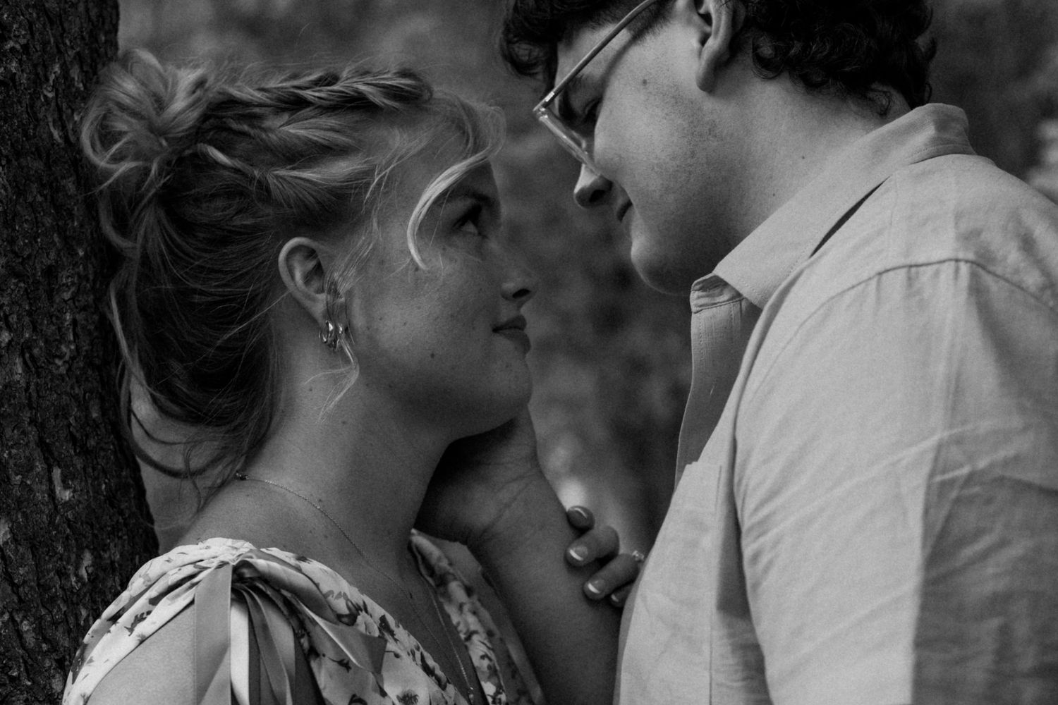 A romantic black and white photo sequence showing an intimate embrace against a dark background.