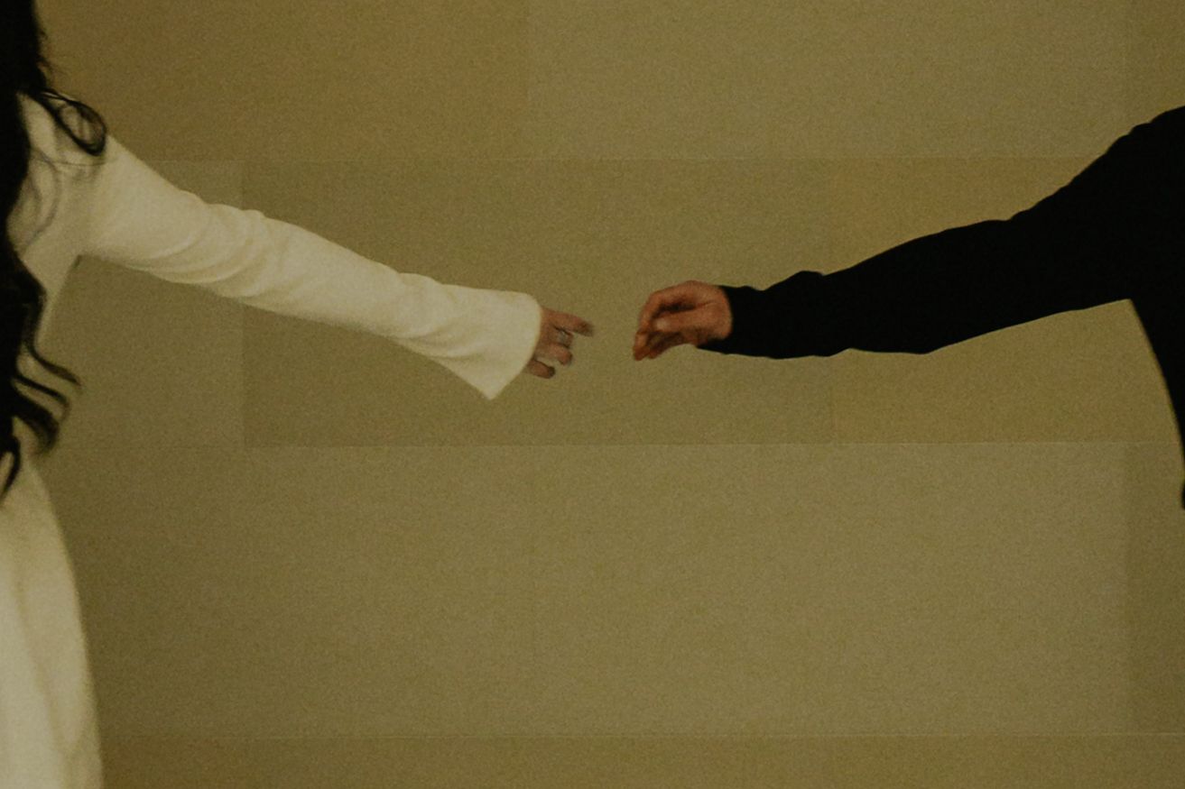 Romantic sequence of hands reaching across a sepia-toned background.
