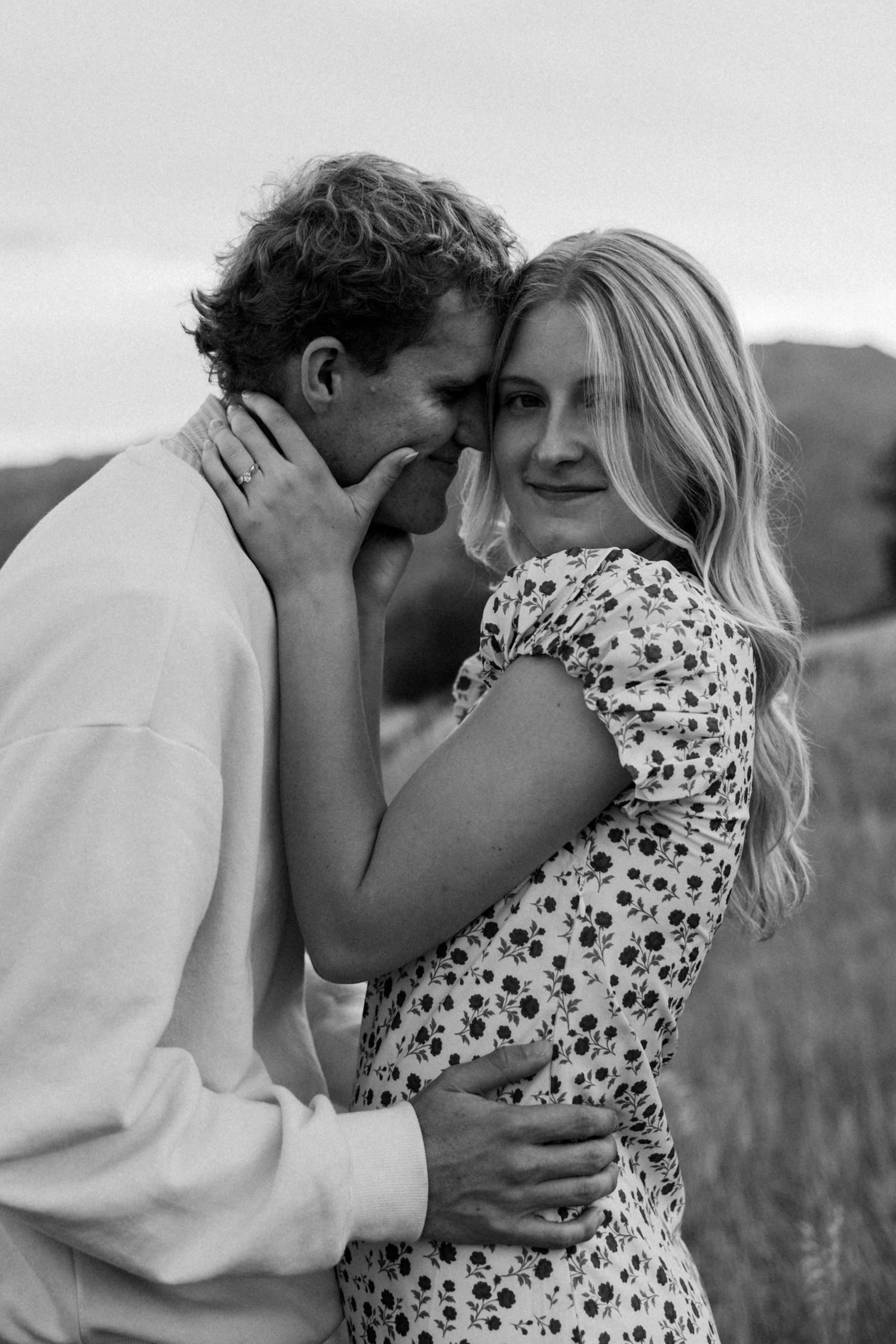 An intimate black and white portrait sequence of a couple in a meadow.
