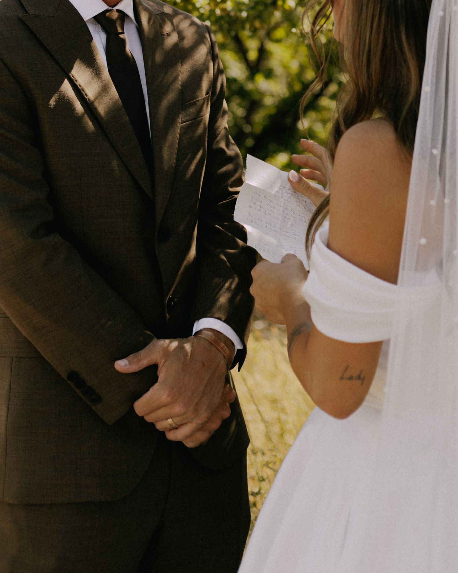Close-up details of a bride and groom during an intimate wedding ceremony.