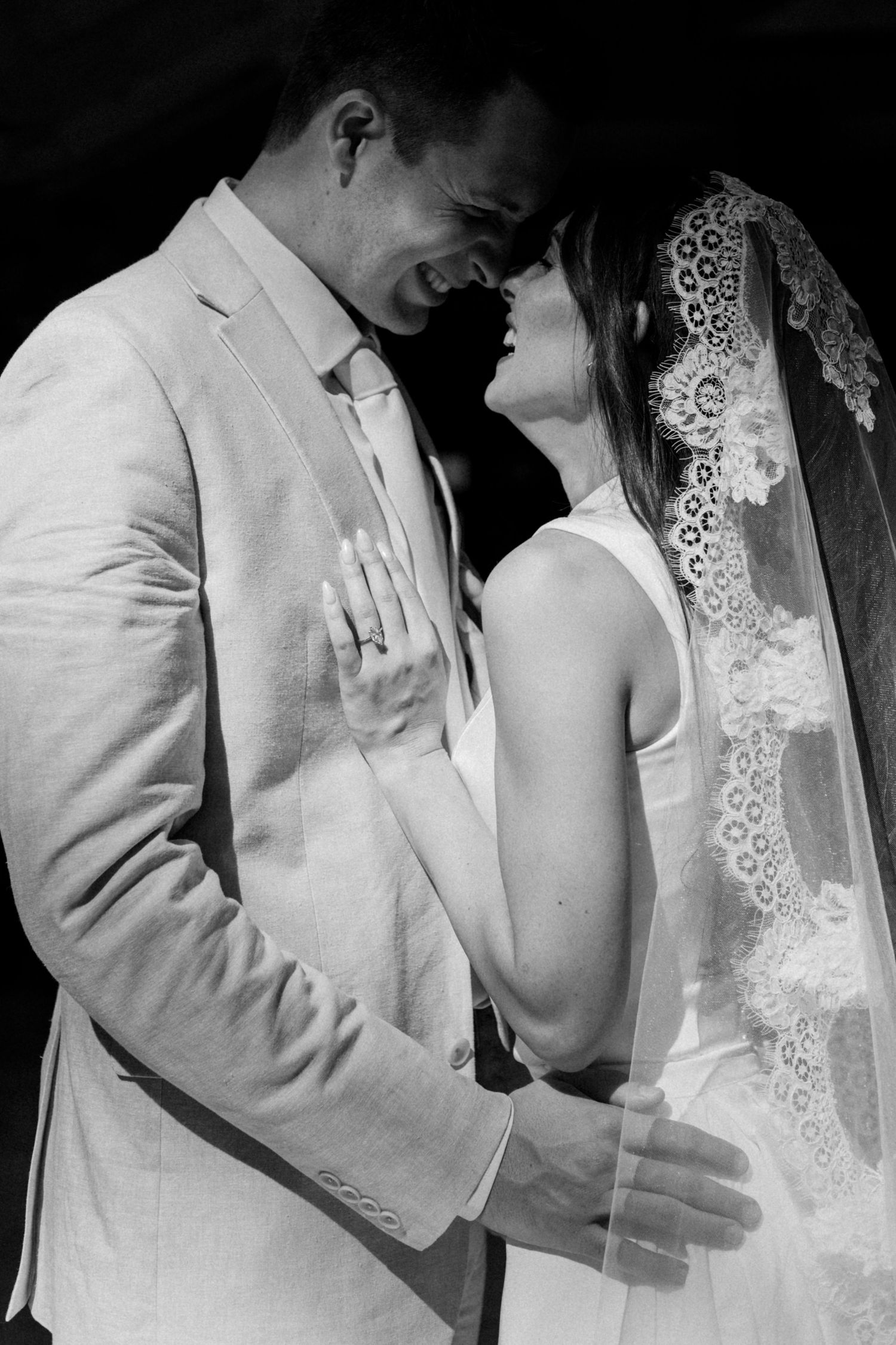 Close-up sequence of bride and groom sharing tender moments in black and white photography.