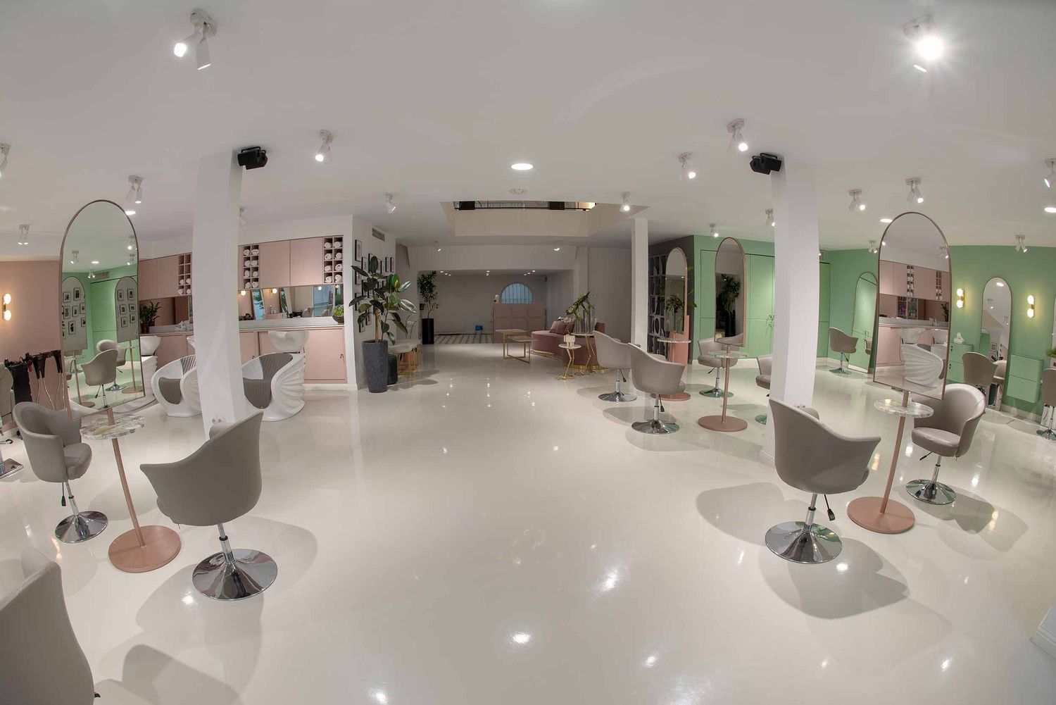 A modern white showroom with display lighting and gallery-style exhibition spaces showcases design elements in multiple views.