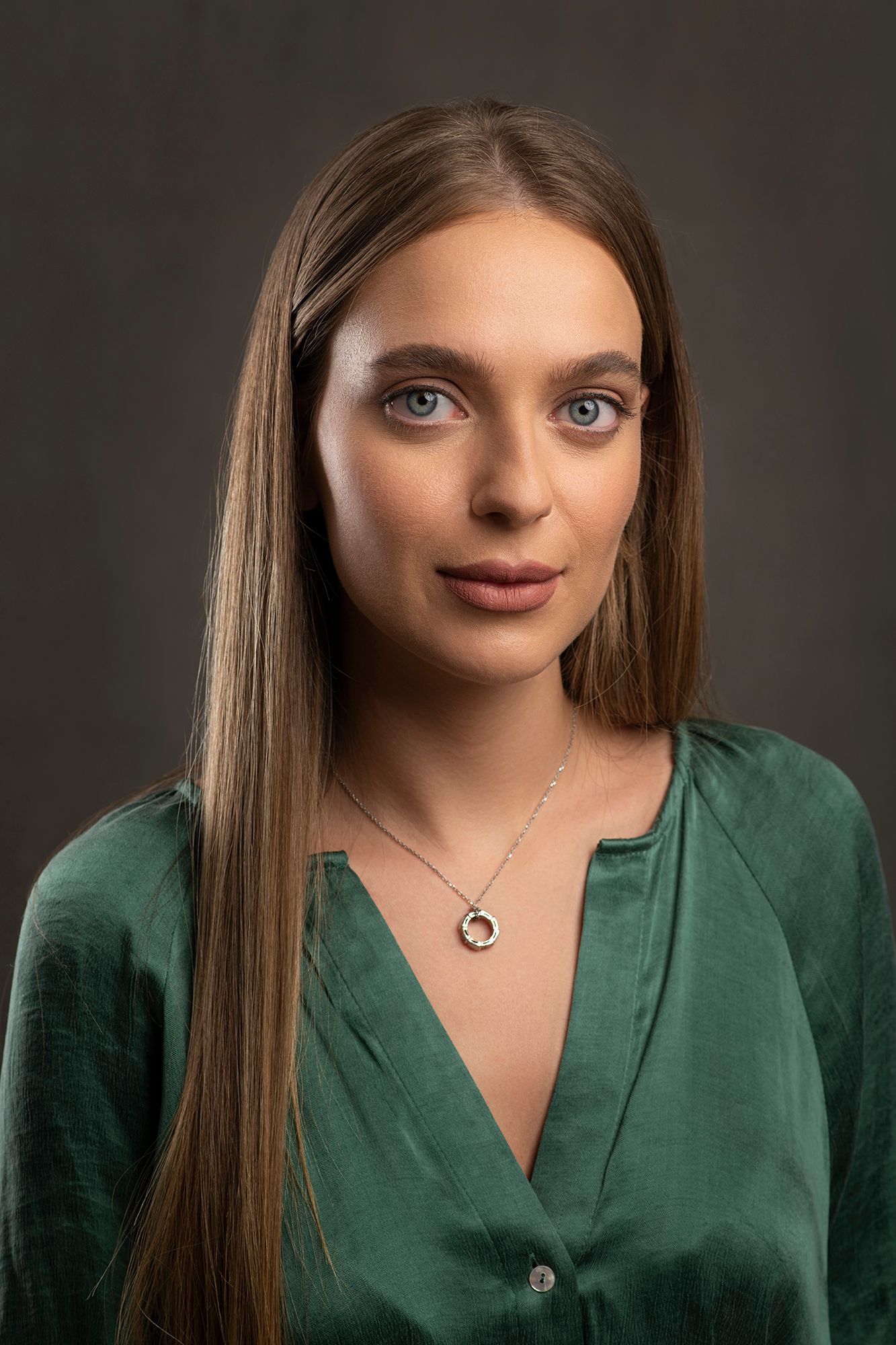 Professional portrait and headshot of young woman with long straight hair wearing green silk blouse taken in west Los Angeles.