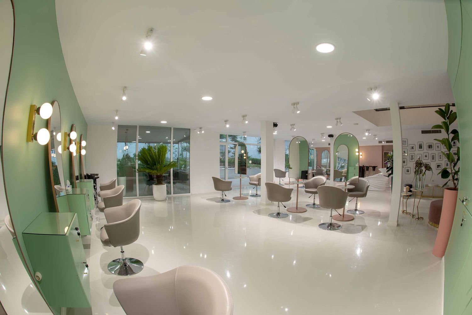 Modern dental office interior with white decor, green accent walls and multiple treatment rooms in a bright corridor.