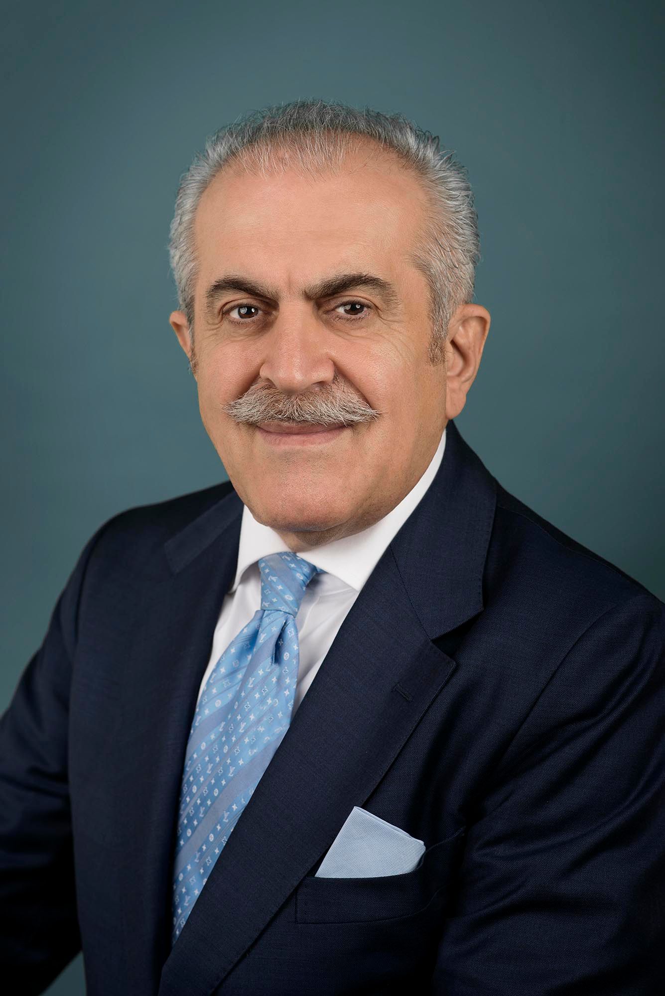 Executive portrait of senior businessman in navy suit with light blue tie taken in West los Angeles.