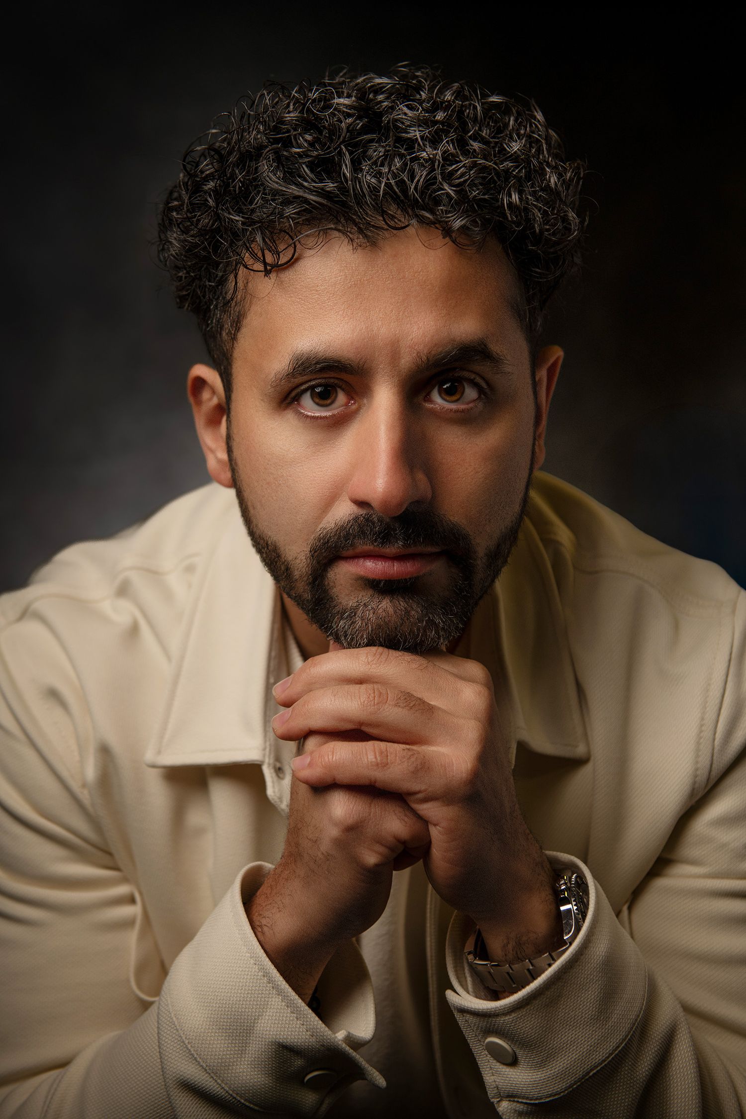 Artistic portrait series in cream colored shirt with contemplative poses taken in Westwood Los Angeles studio.