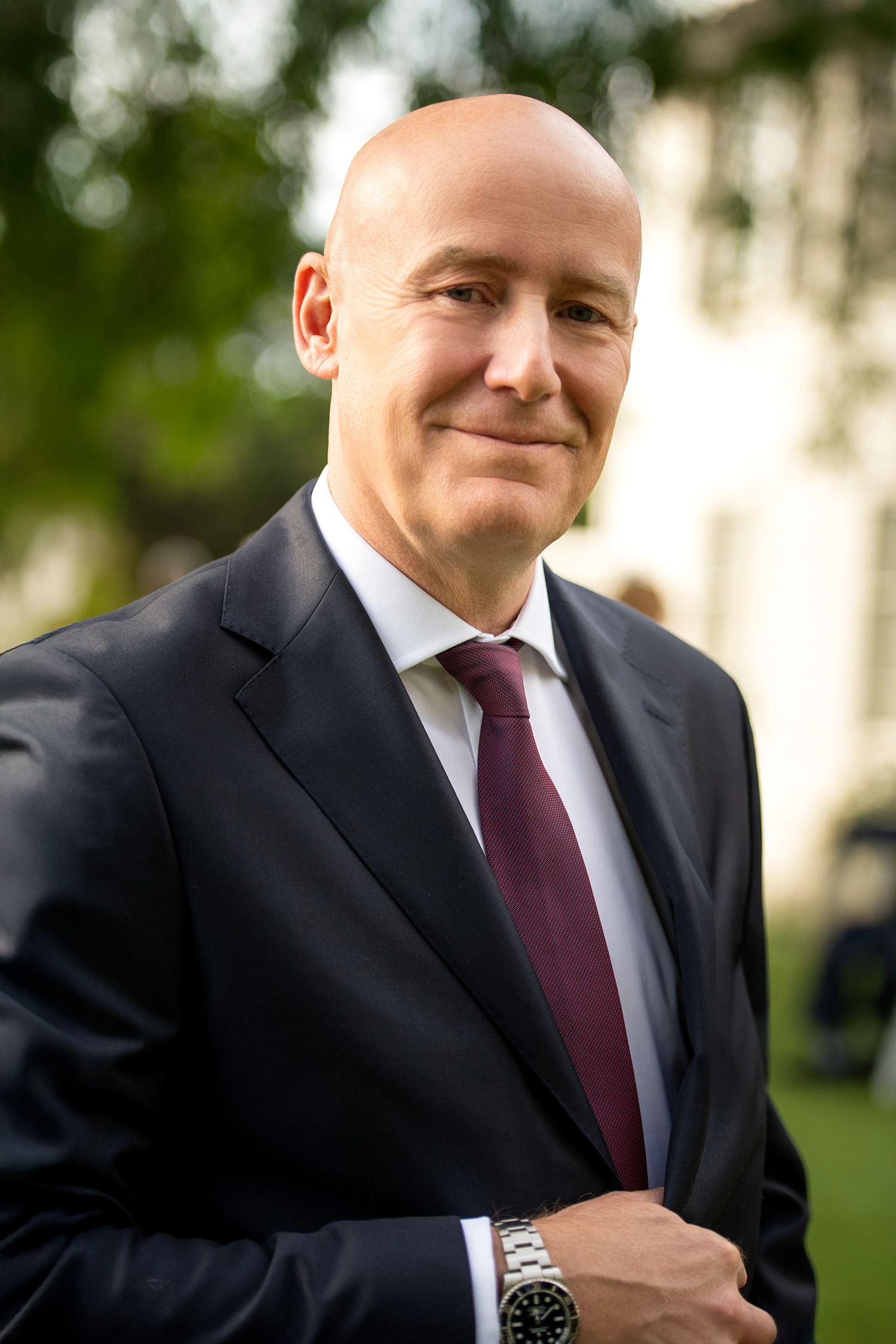 Close-up outdoor portrait and headshot of businessman wearing dark suit and red tie taken in Westwood Los Angeles studio