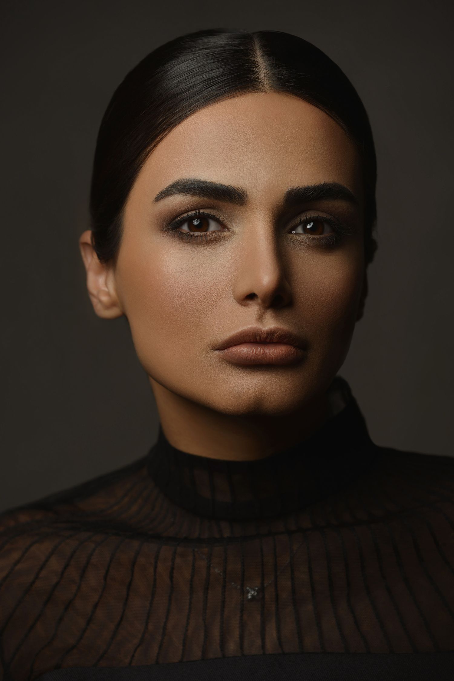 Dramatic close-up beauty portraits with moody lighting highlighting facial features taken in Westwood Los Angeles studio.