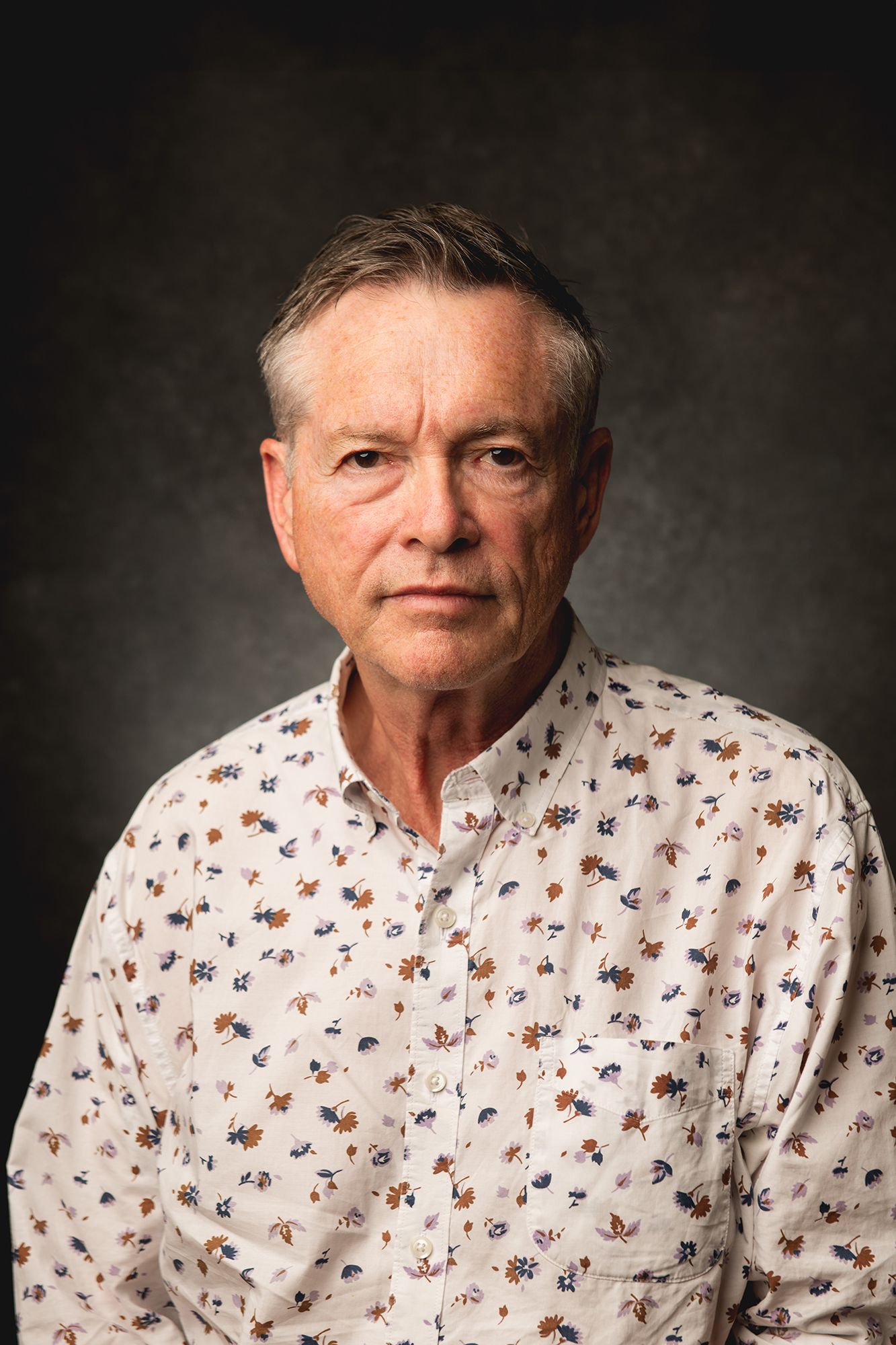 Dramatic Portrait series showing person wearing white patterned shirt against dark dramatic background taken in west Los Angeles.