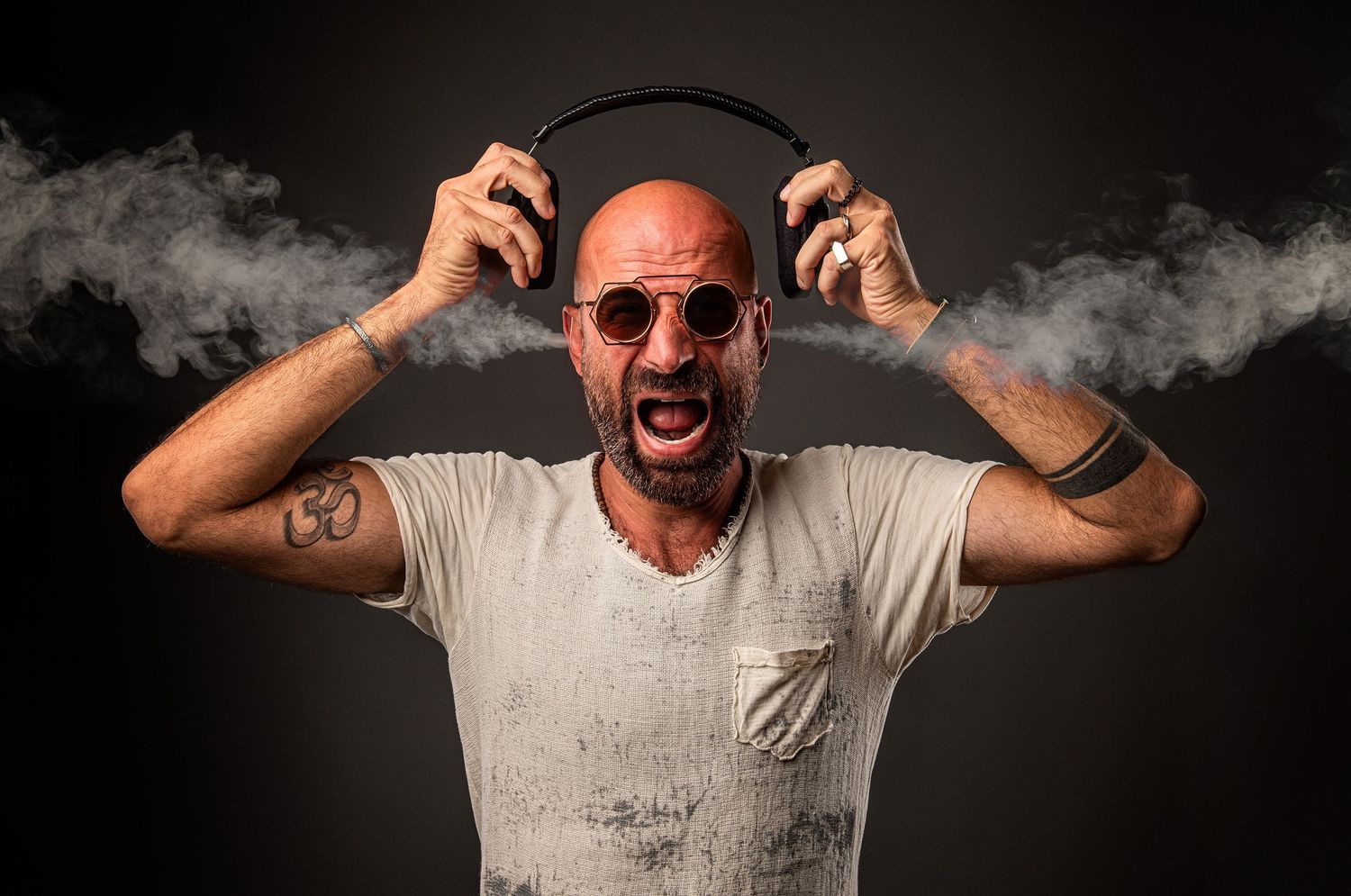 Emotive persian podcaster and comedian Farshid Manafi portrait series showing dramatic expressions with smoke effects.
