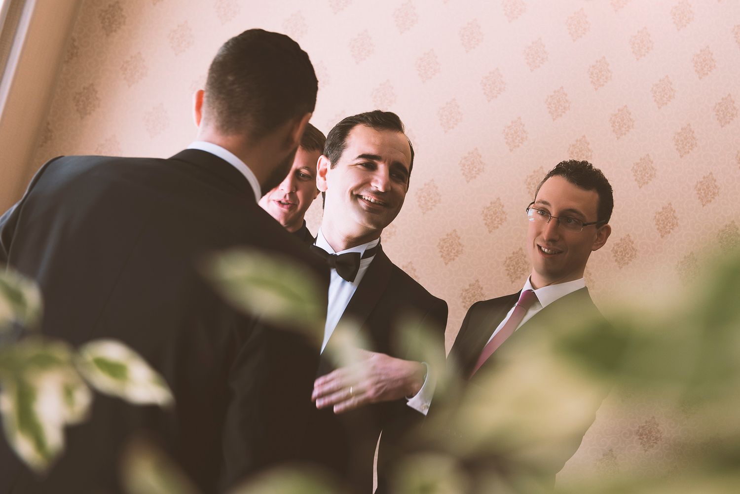 Two people in formal attire embrace during what appears to be a wedding celebration or special event.