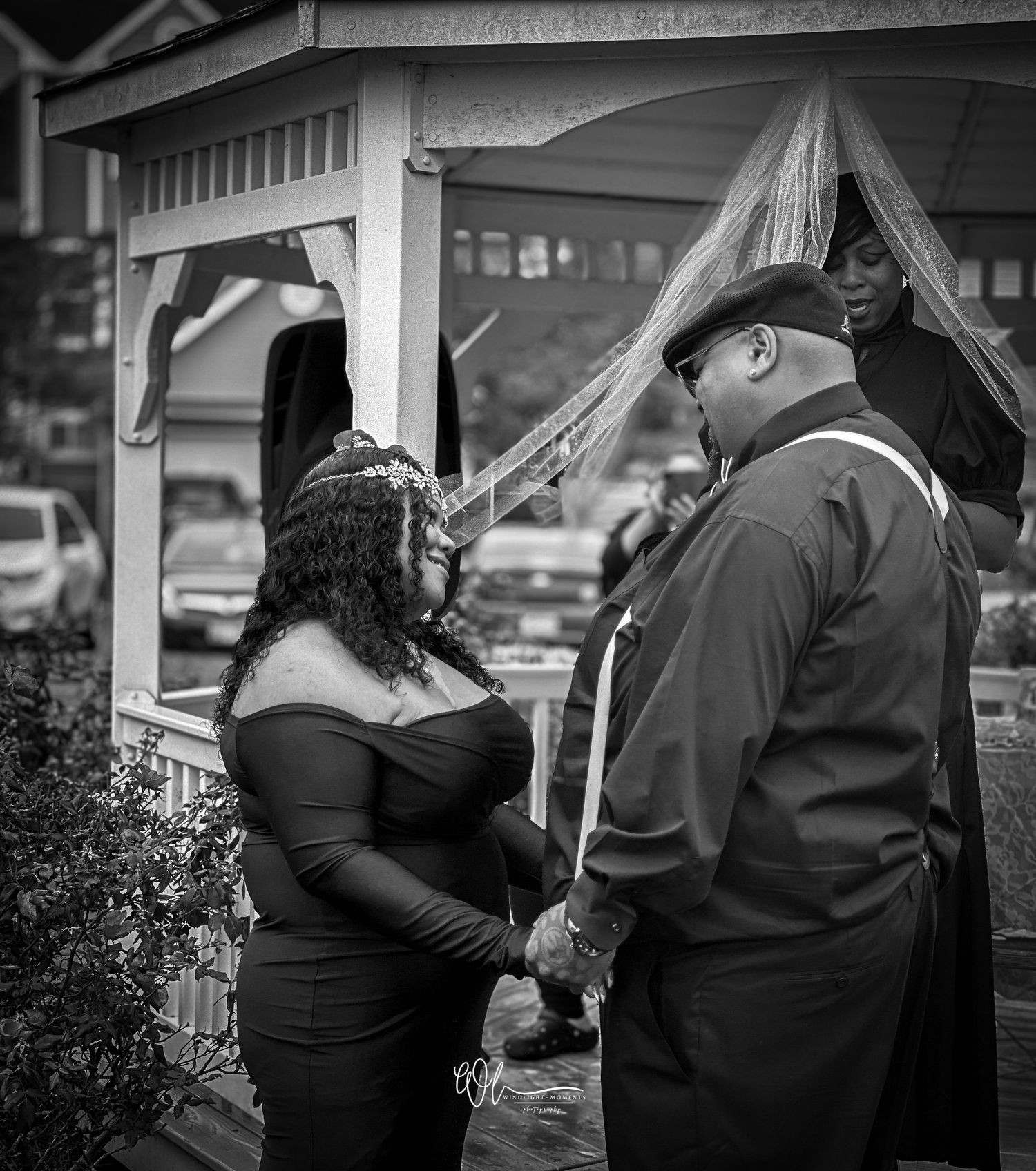 A series of black and white photographs showing couples embracing under umbrellas in the rain.