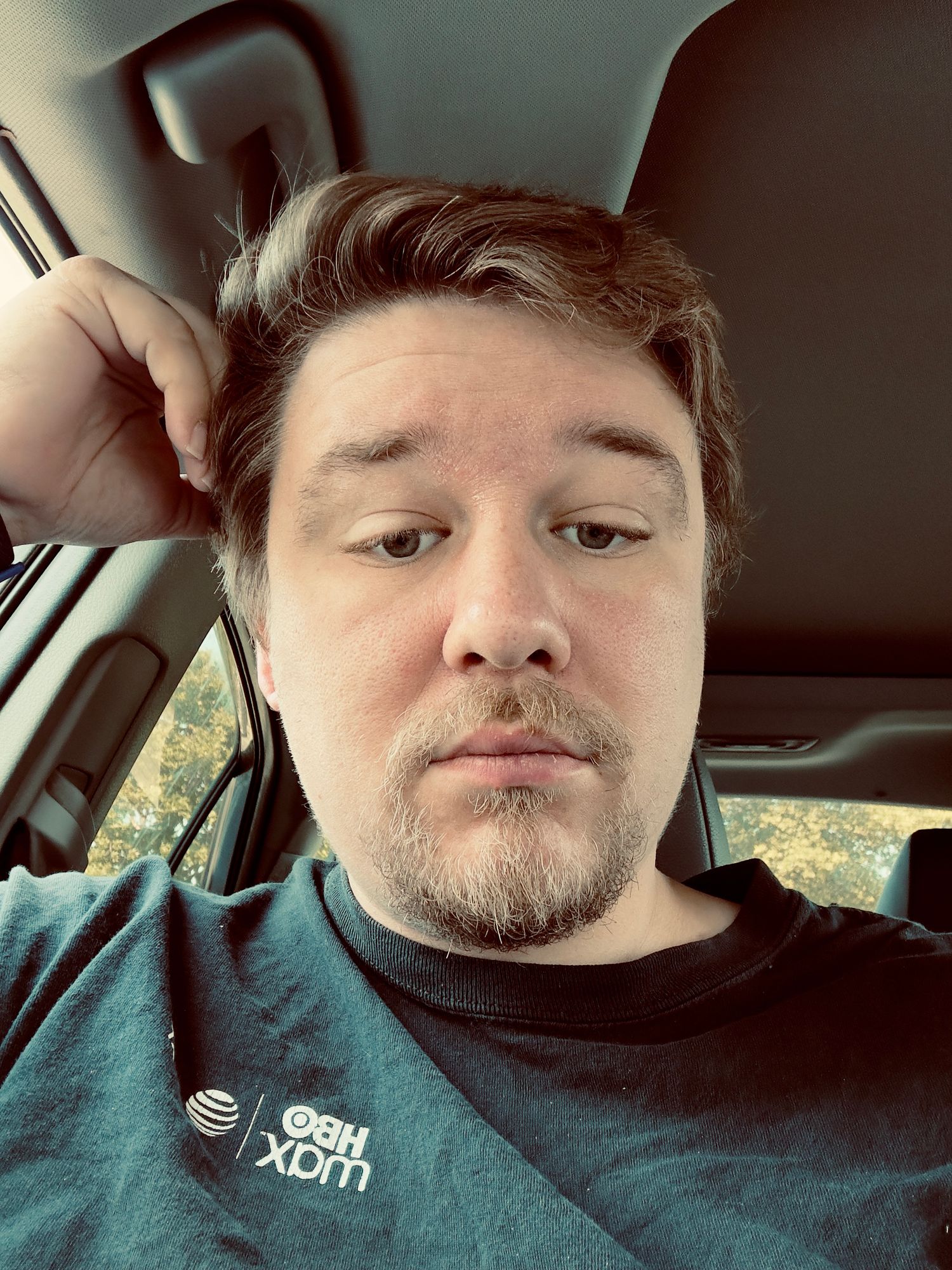 A series of selfies taken inside a car showing someone wearing a dark colored shirt.