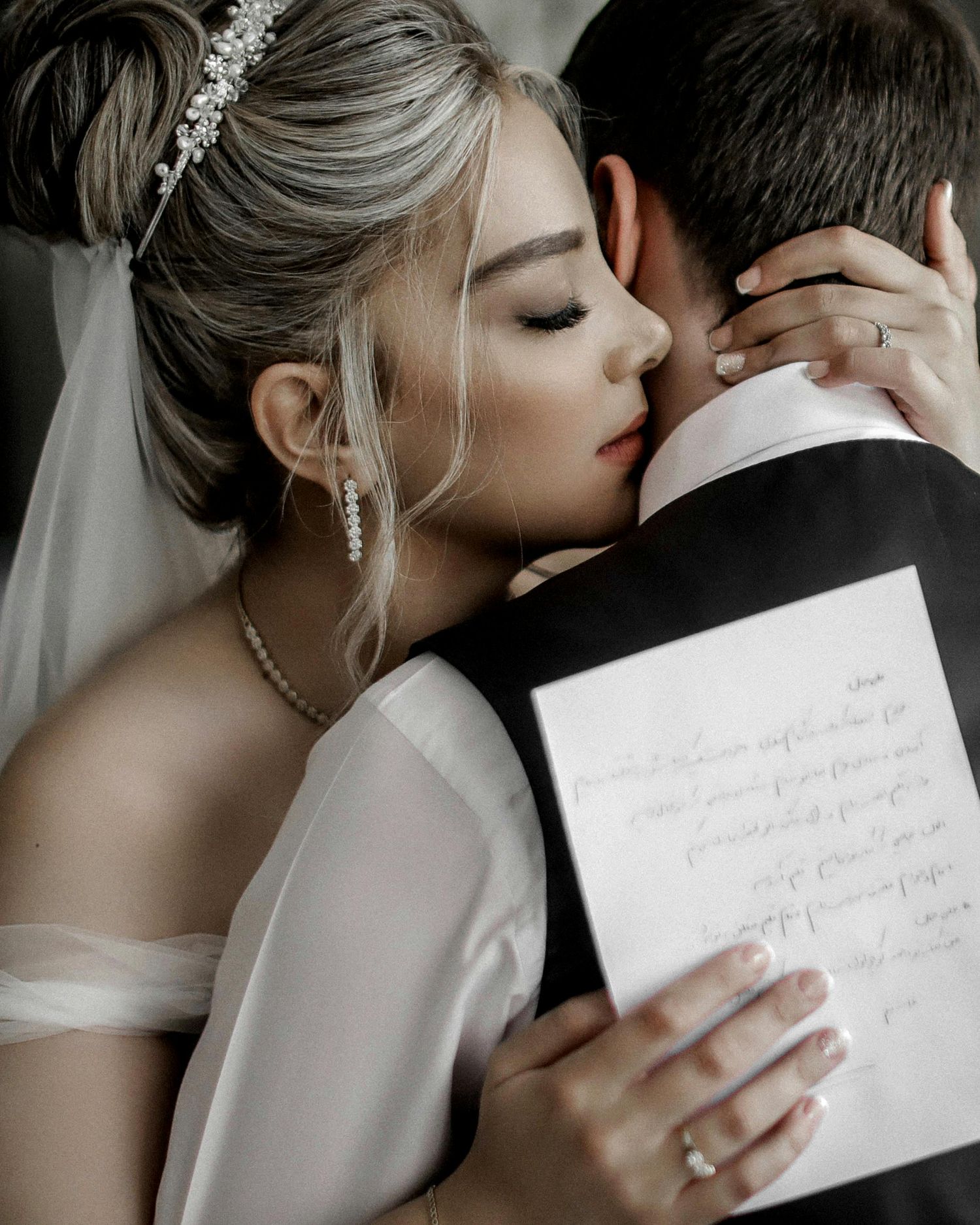Close-up of bride holding vows while sharing intimate moment.
