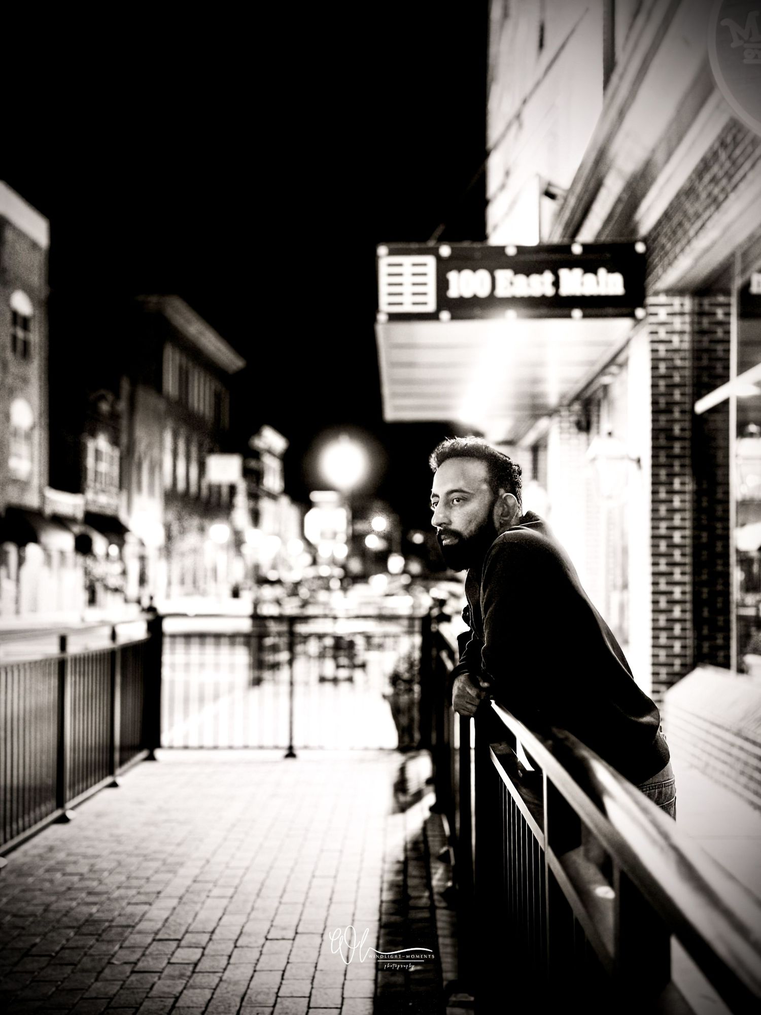 A black and white photo series showing a person walking through a dimly lit subway station corridor.