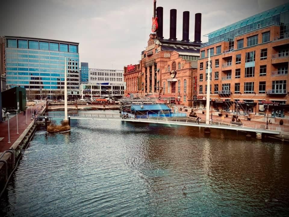 Historic brick industrial waterfront buildings along an urban canal or harbor.