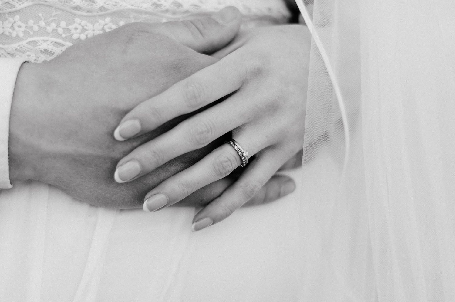 Close up on pregnancy belly with hands with wedding rings