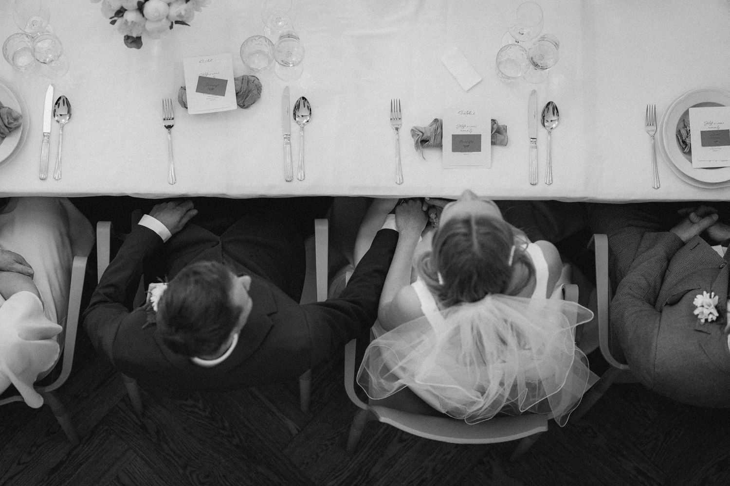 Overhead black and white view of wedding reception table settings.