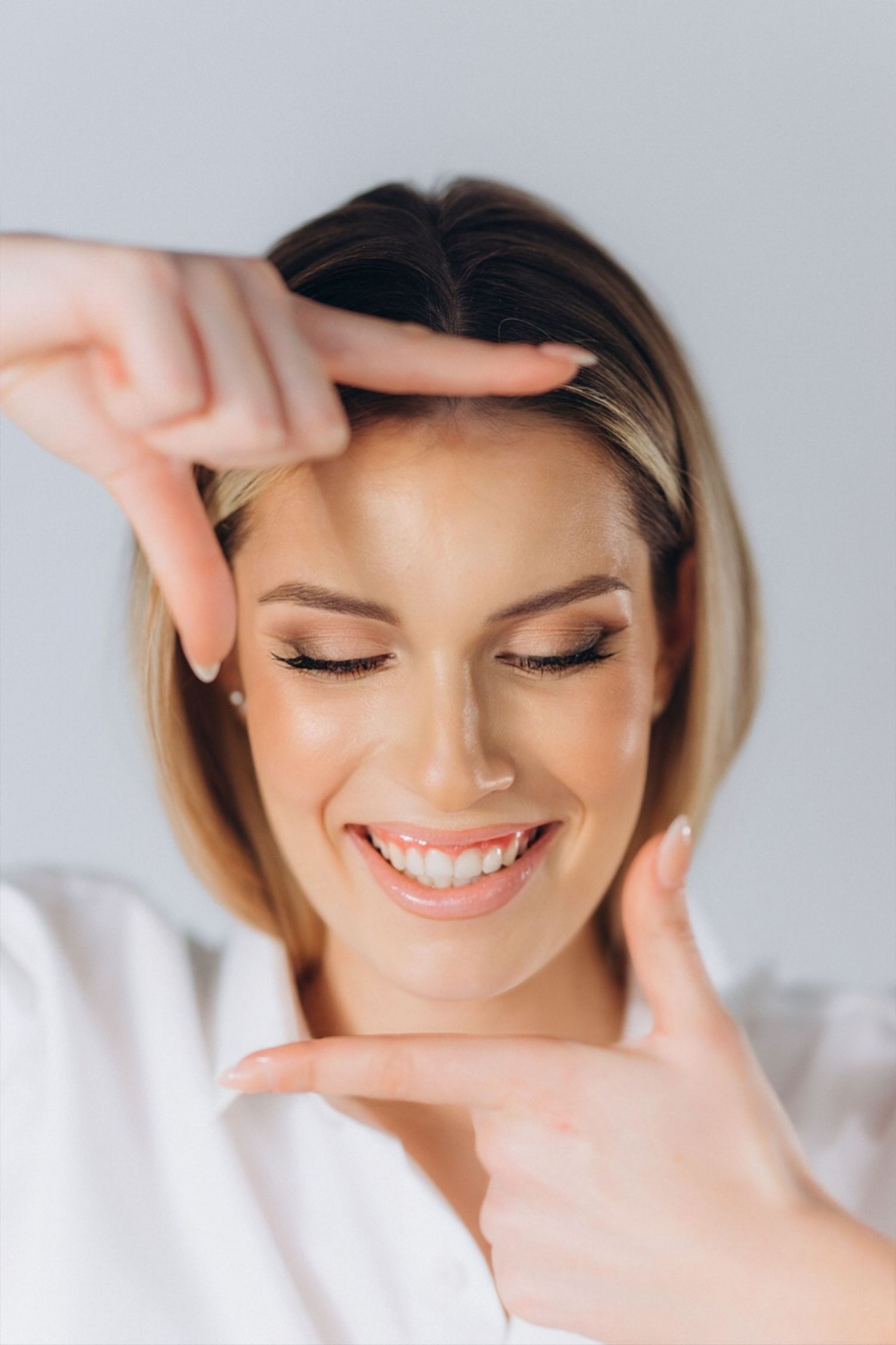 Close-up portrait showing joyful expression and natural makeup.