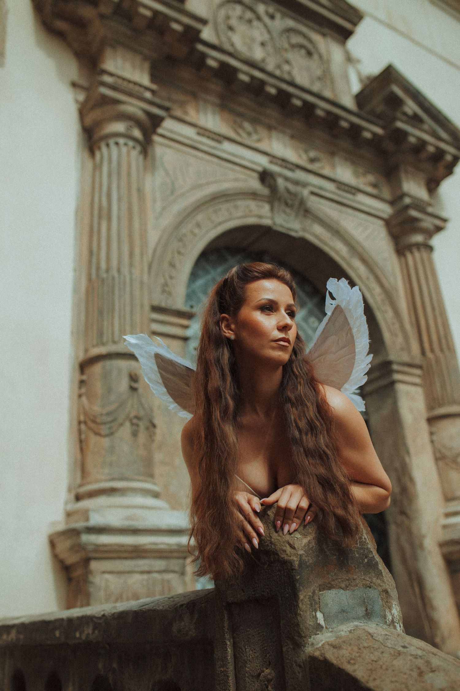 Fantasy portrait near classical stone architecture with ornate columns.