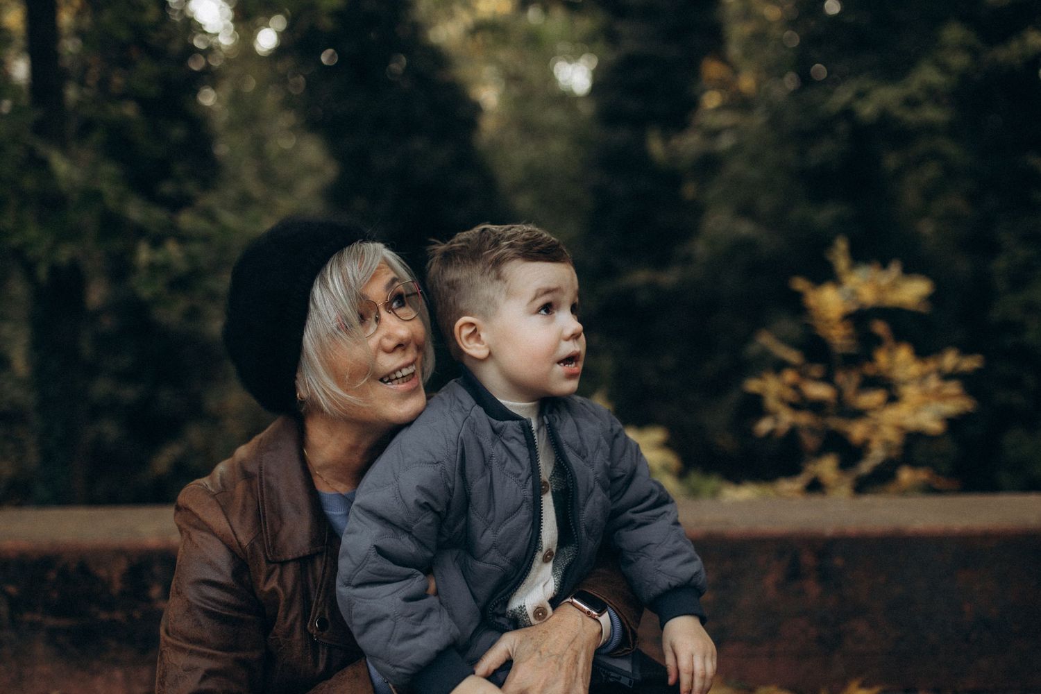Heartwarming autumn scene with two figures sitting together on a bench.