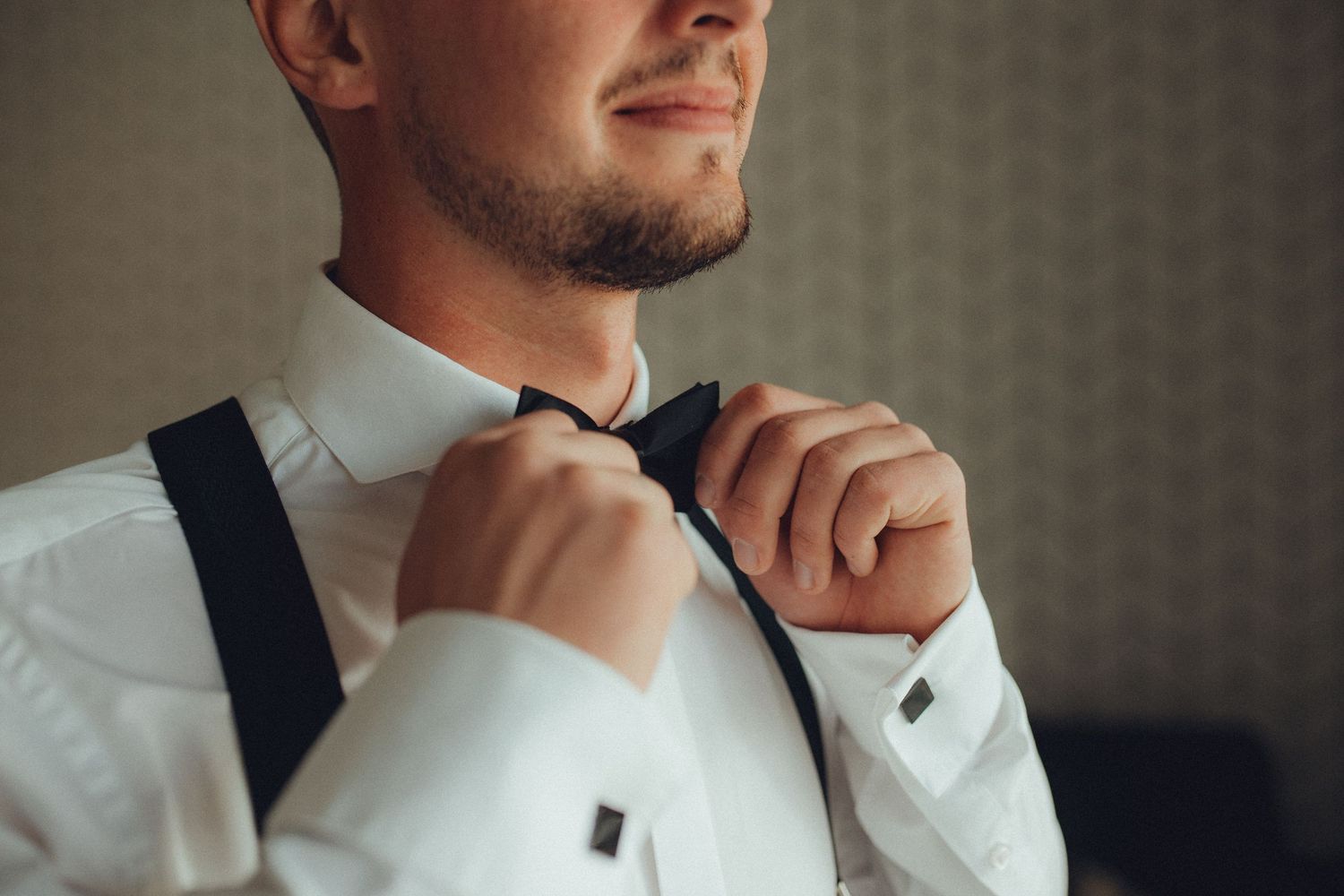 Close-up shots of a black bow tie and white dress shirt collar.