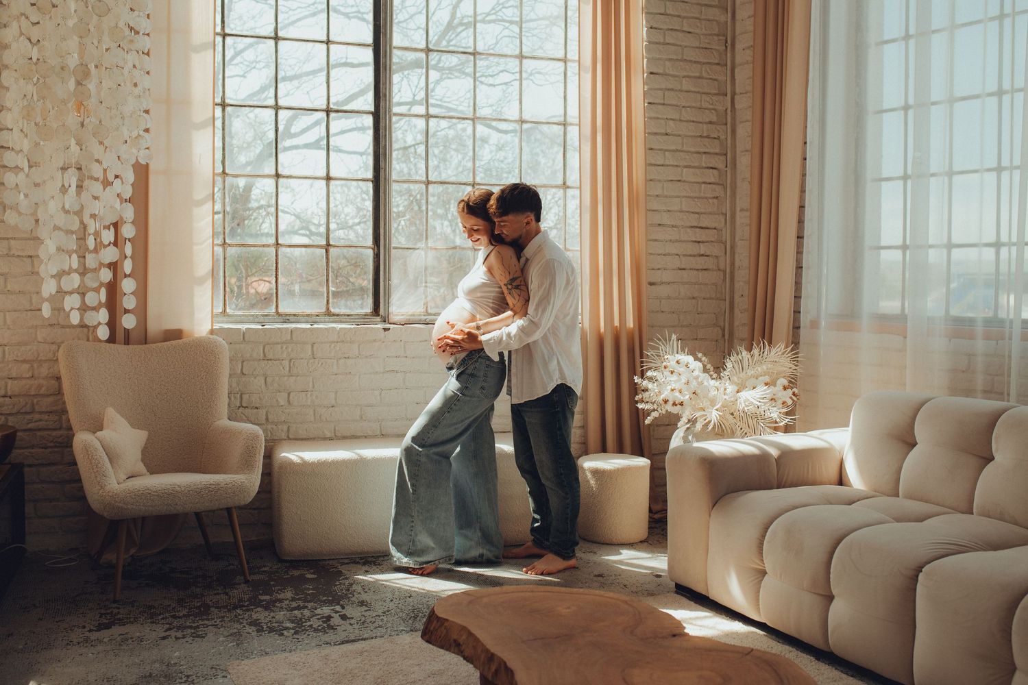 Tender embrace in sunlit living room with modern decor and furniture.