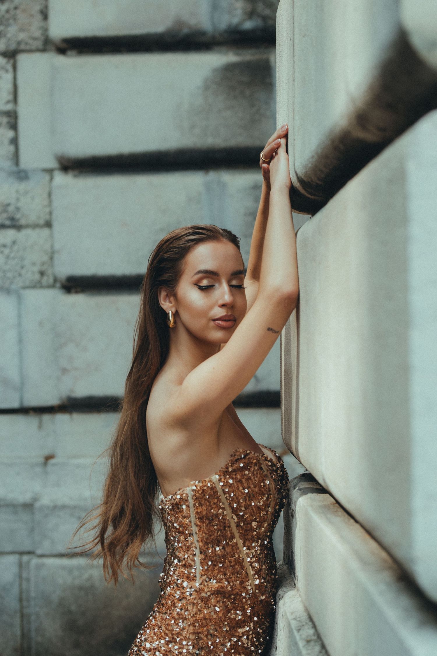 Woman in sparkling bronze dress poses gracefully against white columns in artistic photo sequence.