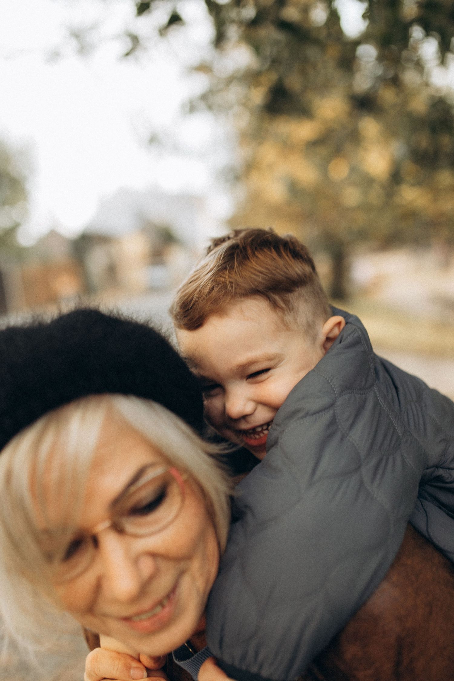 Candid close-up shot capturing playful laughter during an autumn day.