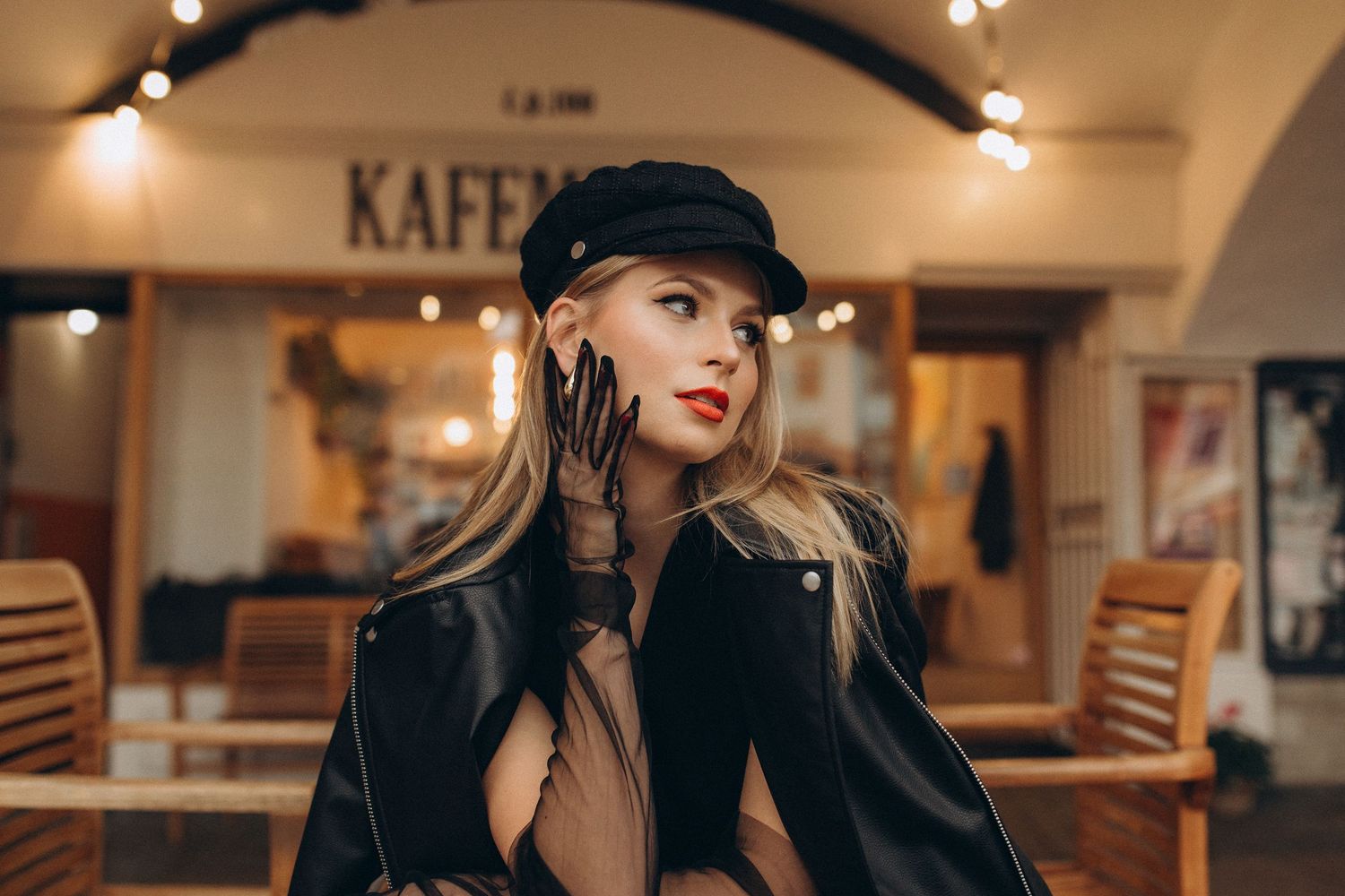Elegant cafe scene portrait with black veil hat and classic vintage styling.