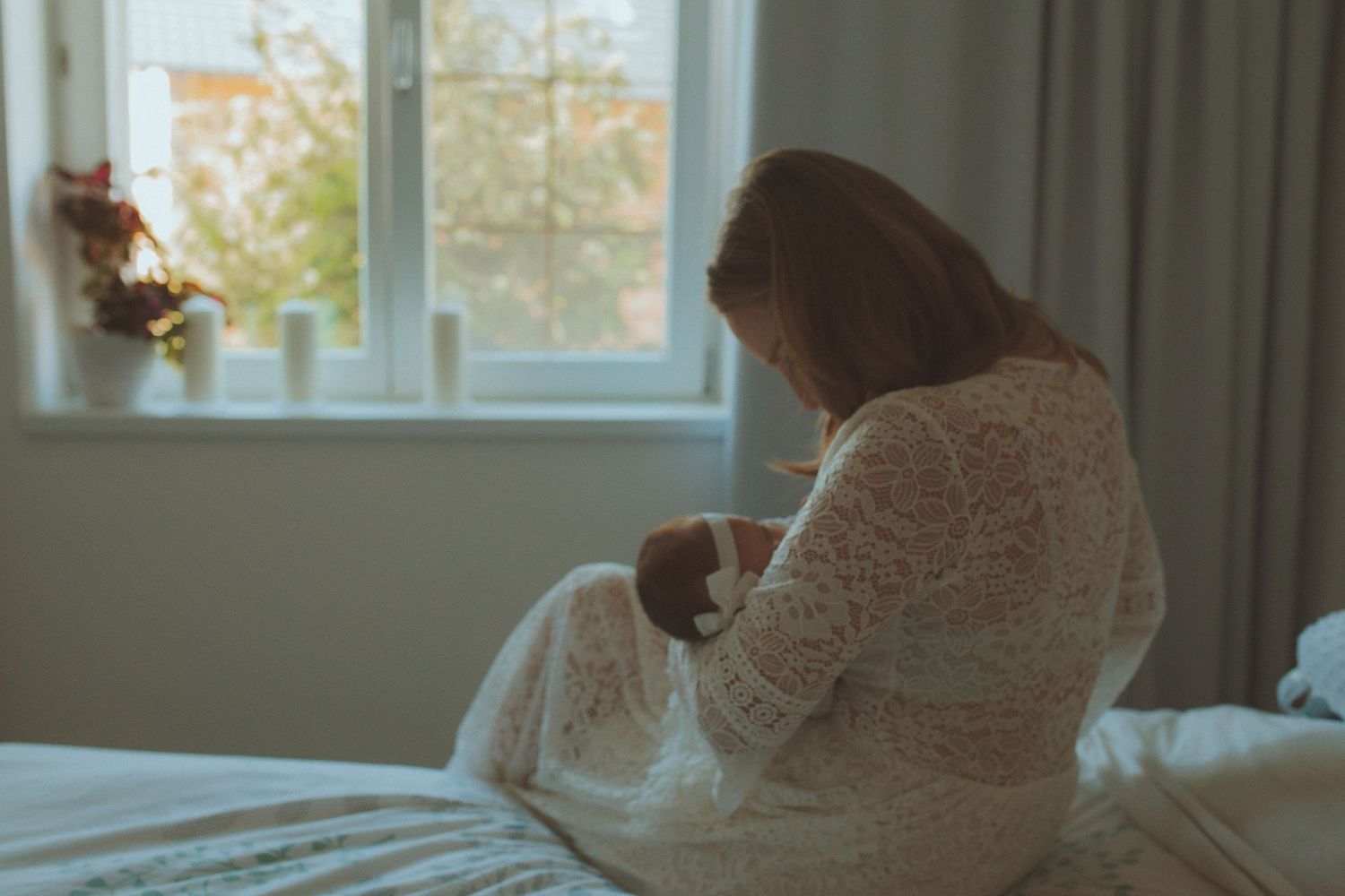 Soft natural light streams through window in indoor maternity setting.