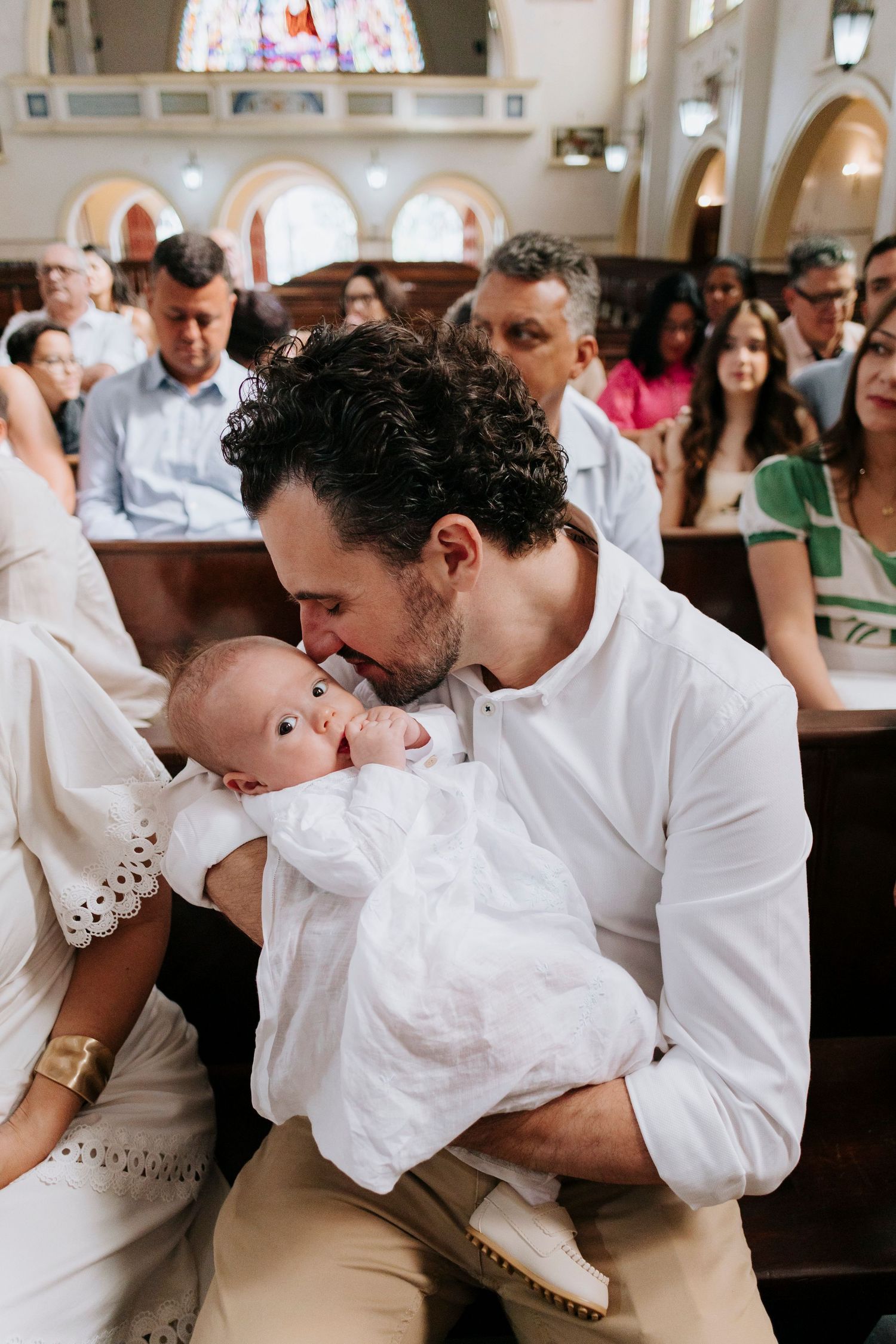 Three candid moments show a couple in white sharing romantic kisses during their wedding celebration.