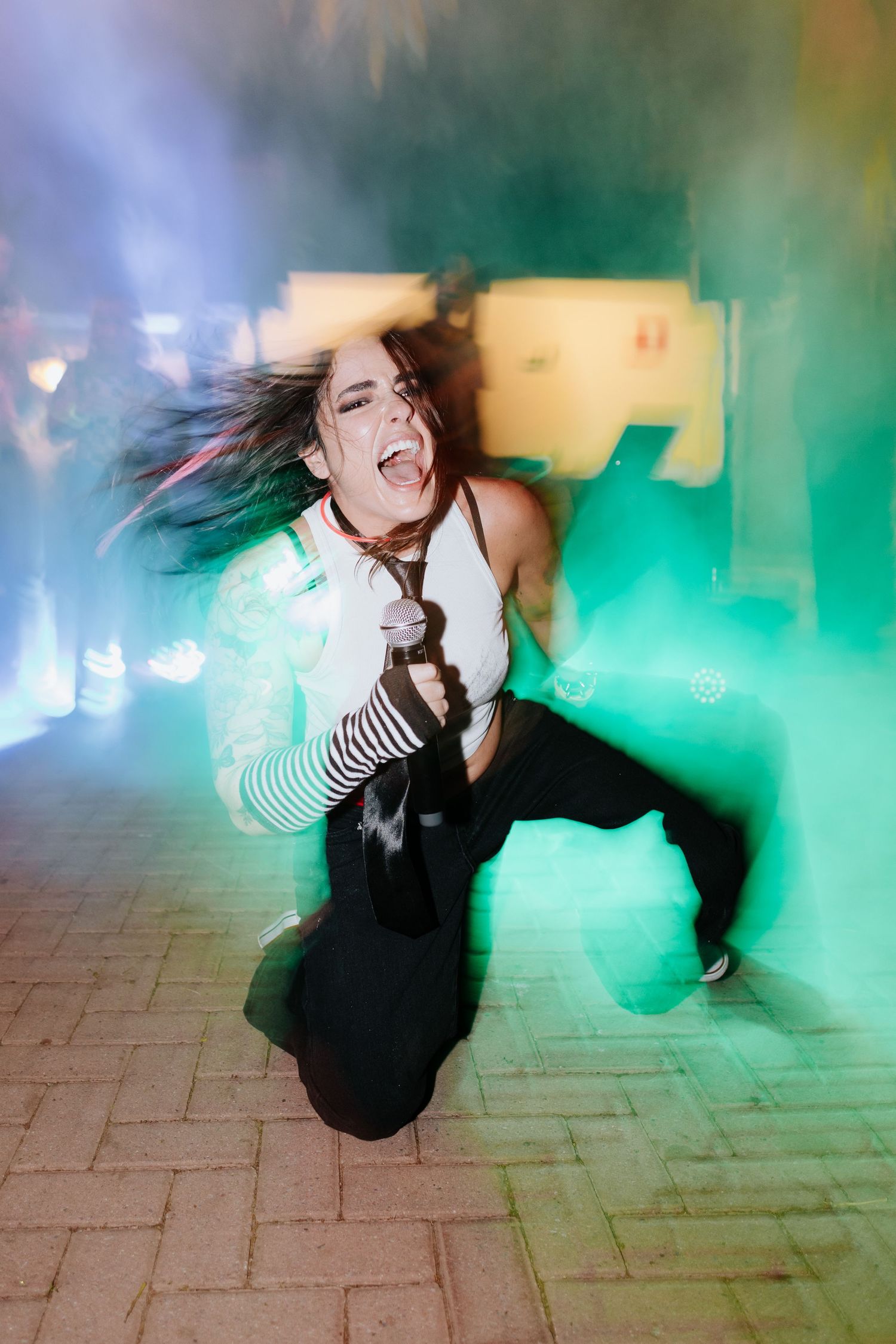 Motion-blurred sequence showing dynamic dance movements against a green-tinted atmospheric background.