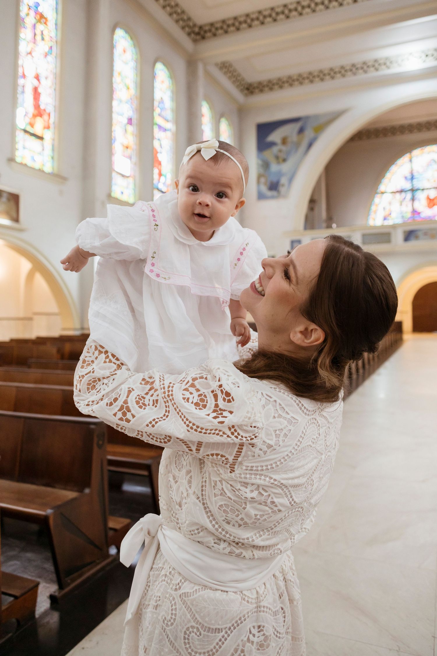 A joyful celebration moment inside a traditional church with stained glass windows and wooden pews.
