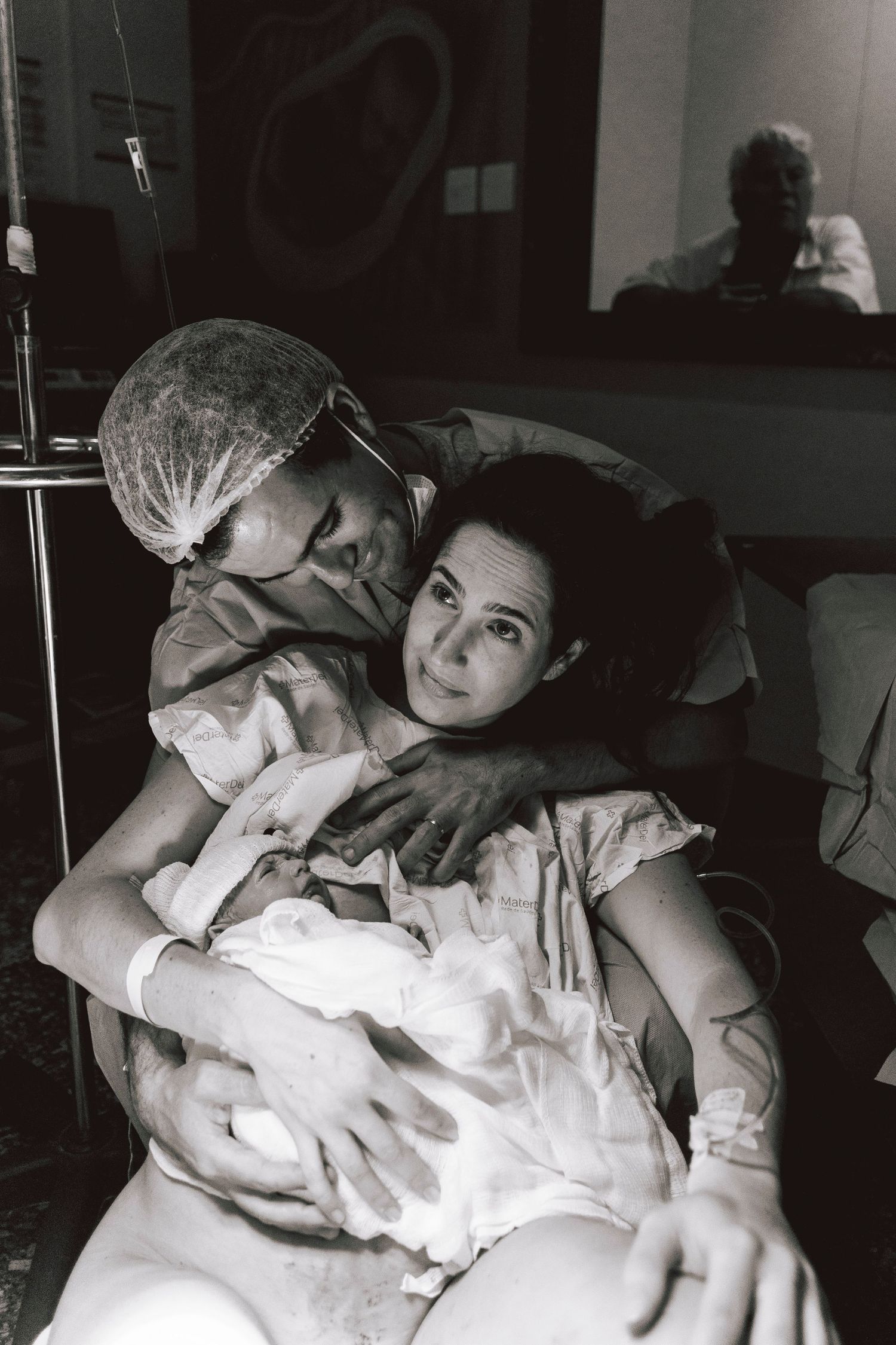 Black and white hospital scene showing tender moments after delivery.
