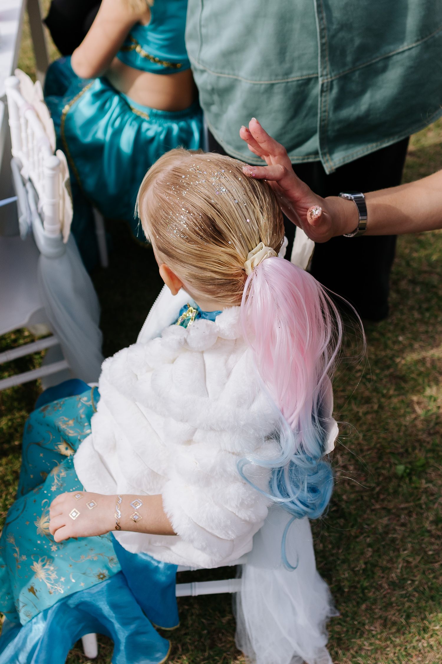 A sequence of photos showing someone fixing a white tulle dress or garment in an outdoor setting.