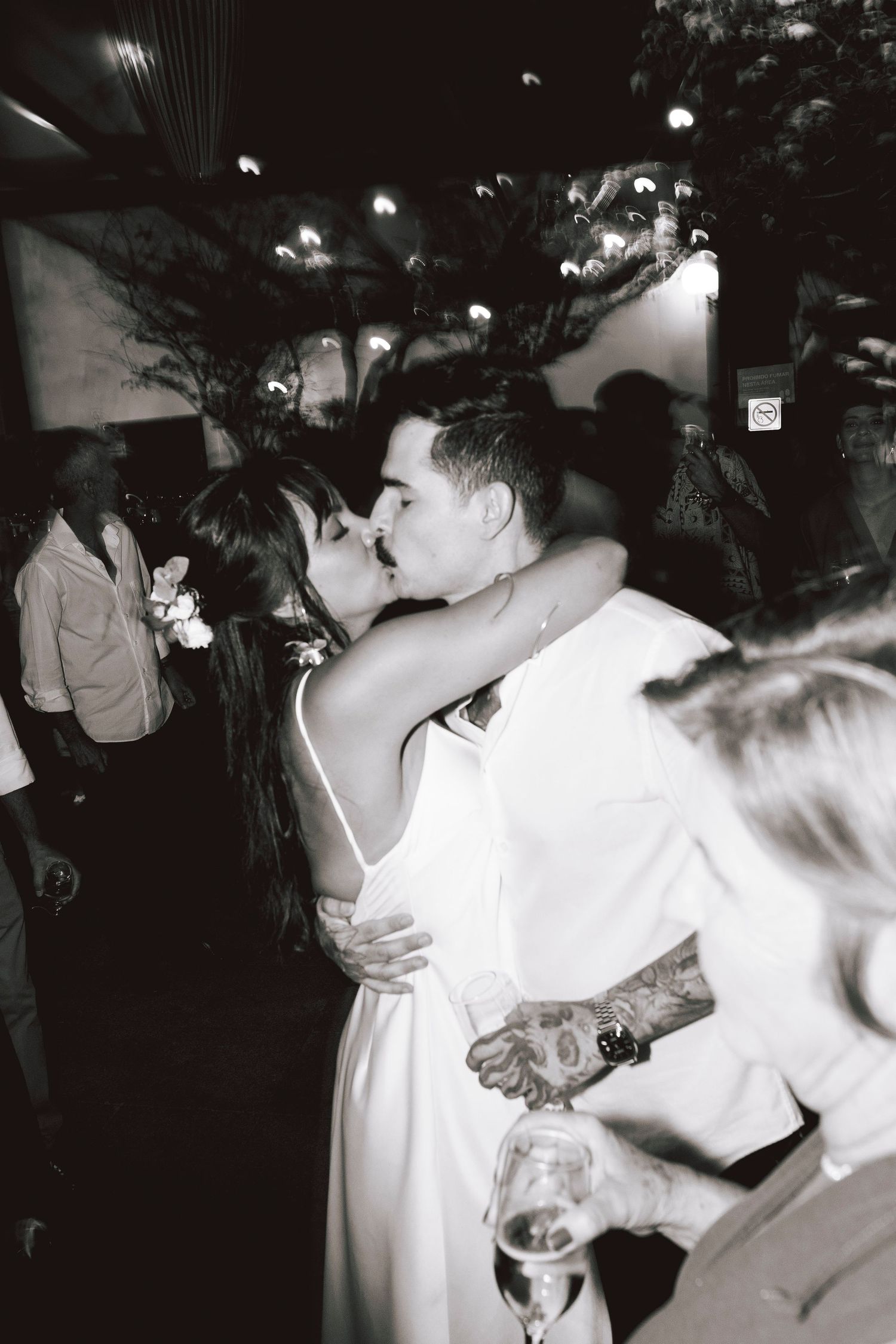 Couple embracing on dance floor during wedding celebration.