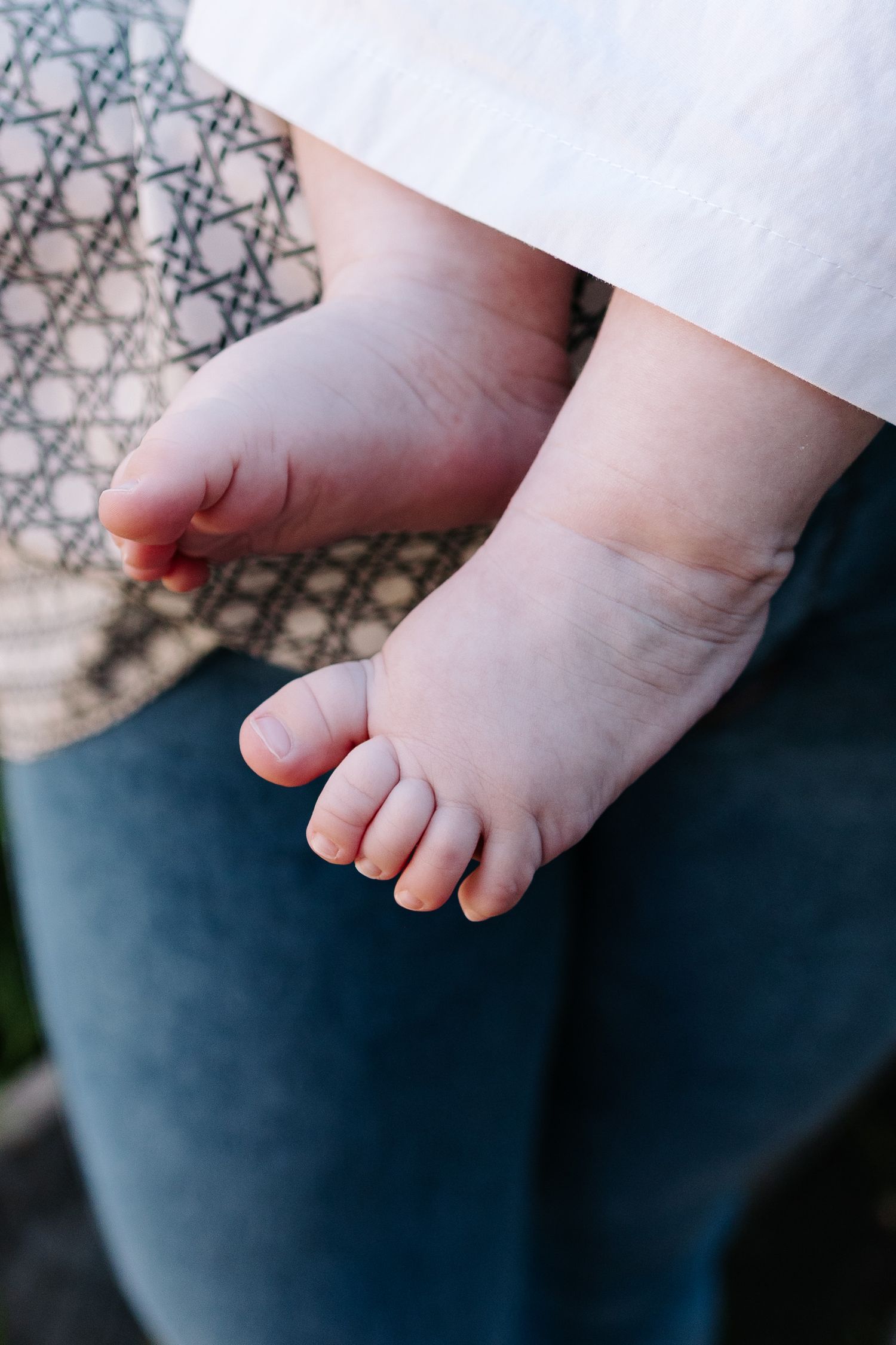 A series of close-up photos showing tiny baby feet against a dark blue background.