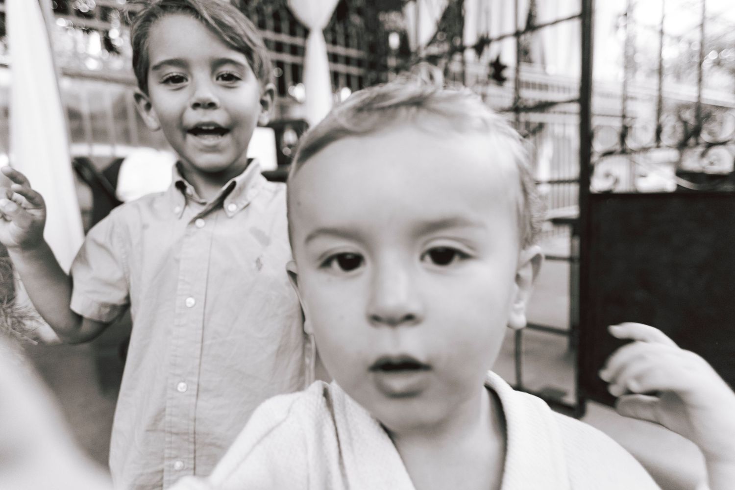 Black and white close-up portrait of two young children with expressive faces.