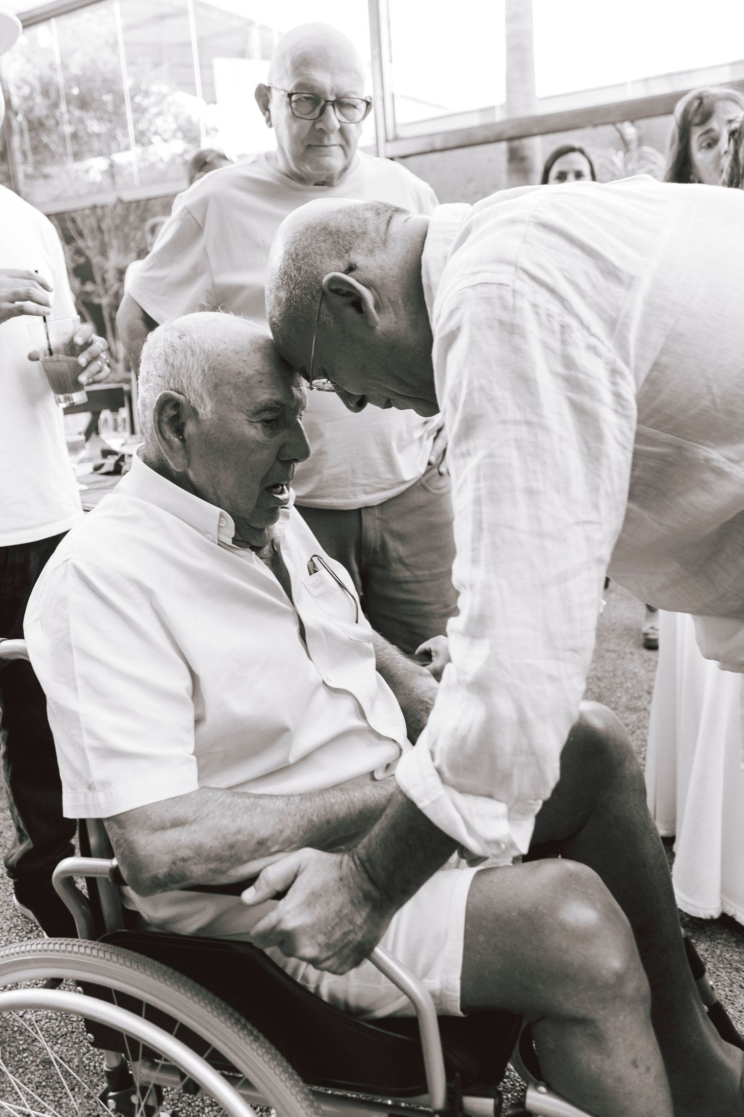 A touching moment between people at what appears to be a family gathering.