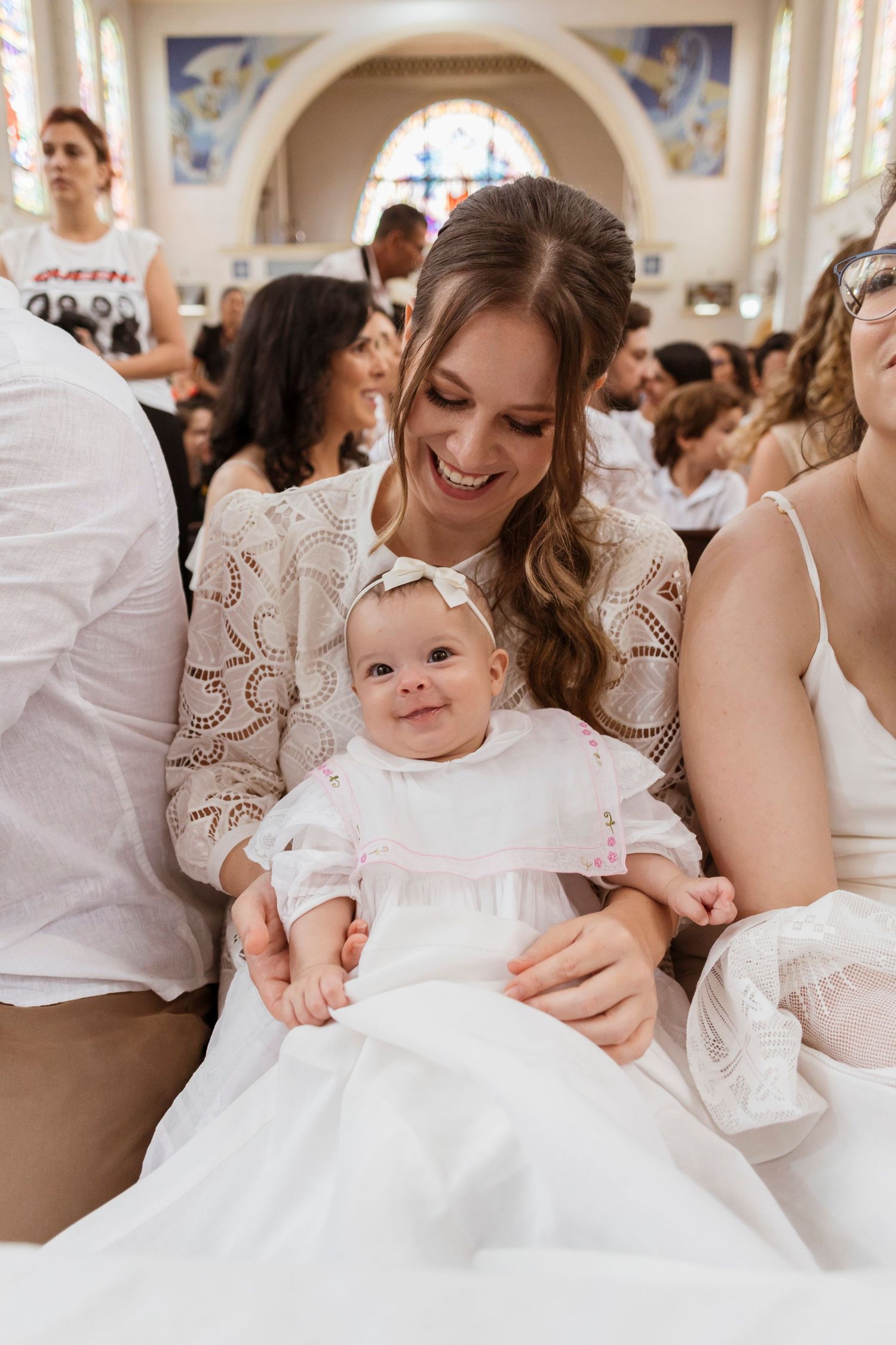 A special moment at a church baptism celebration with guests in formal attire.