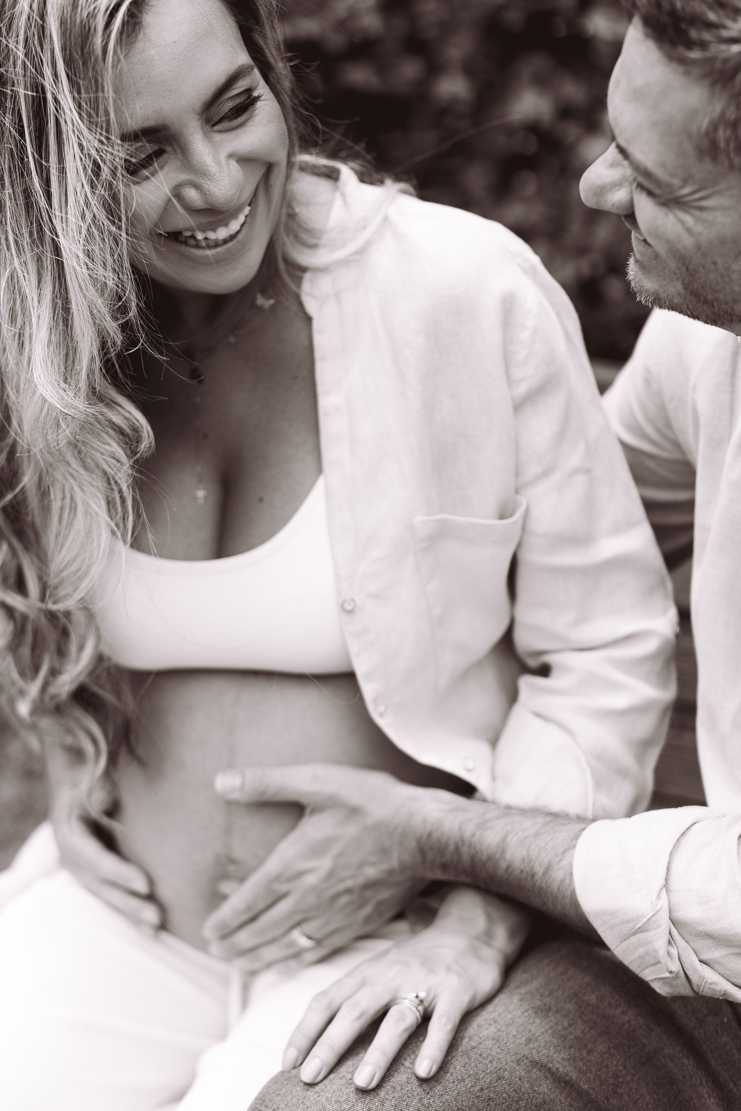 Black and white photo series showing tender moments between a couple in white clothing.