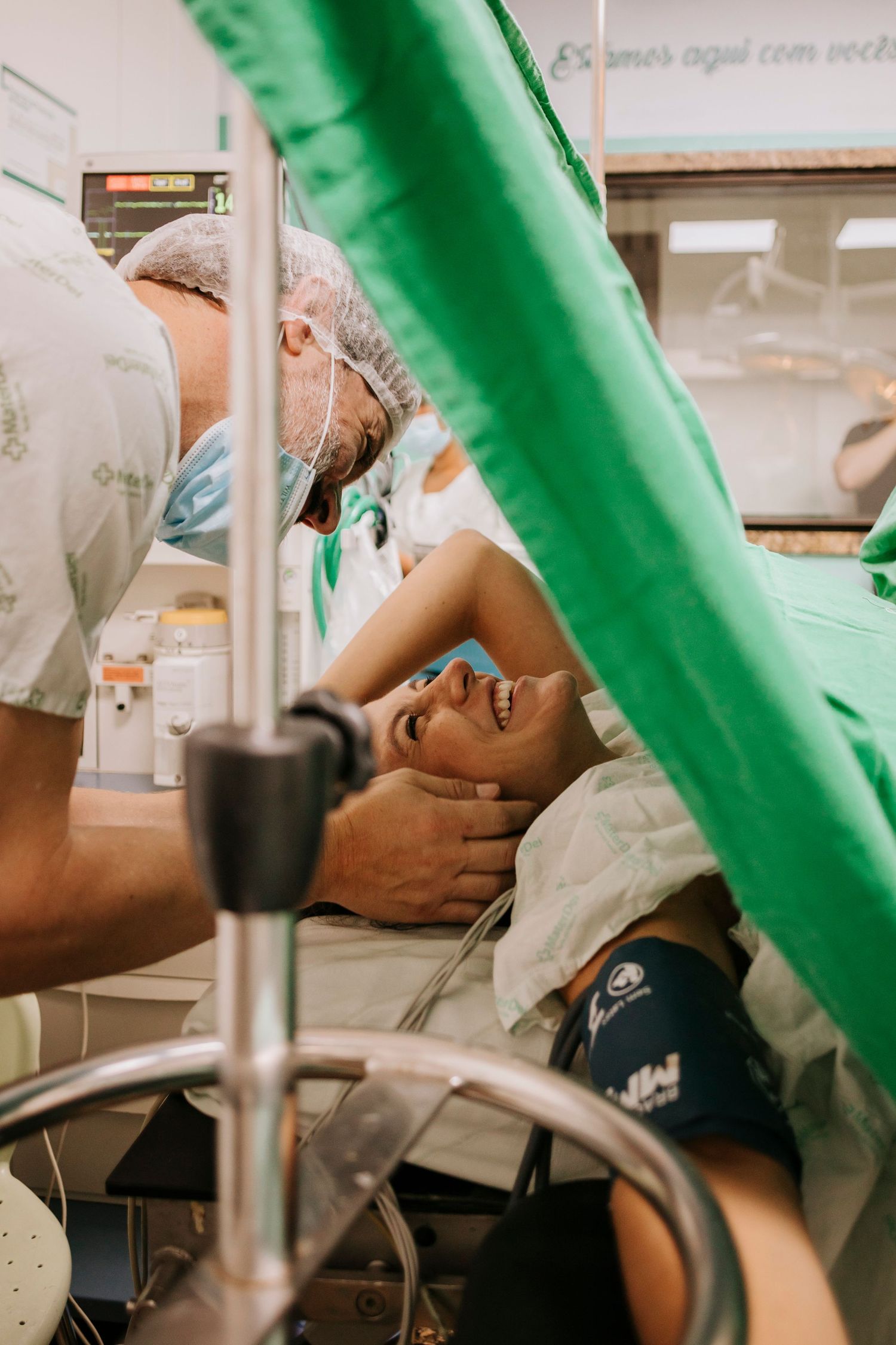 Medical professionals tend to a patient during labor in a modern hospital delivery room.