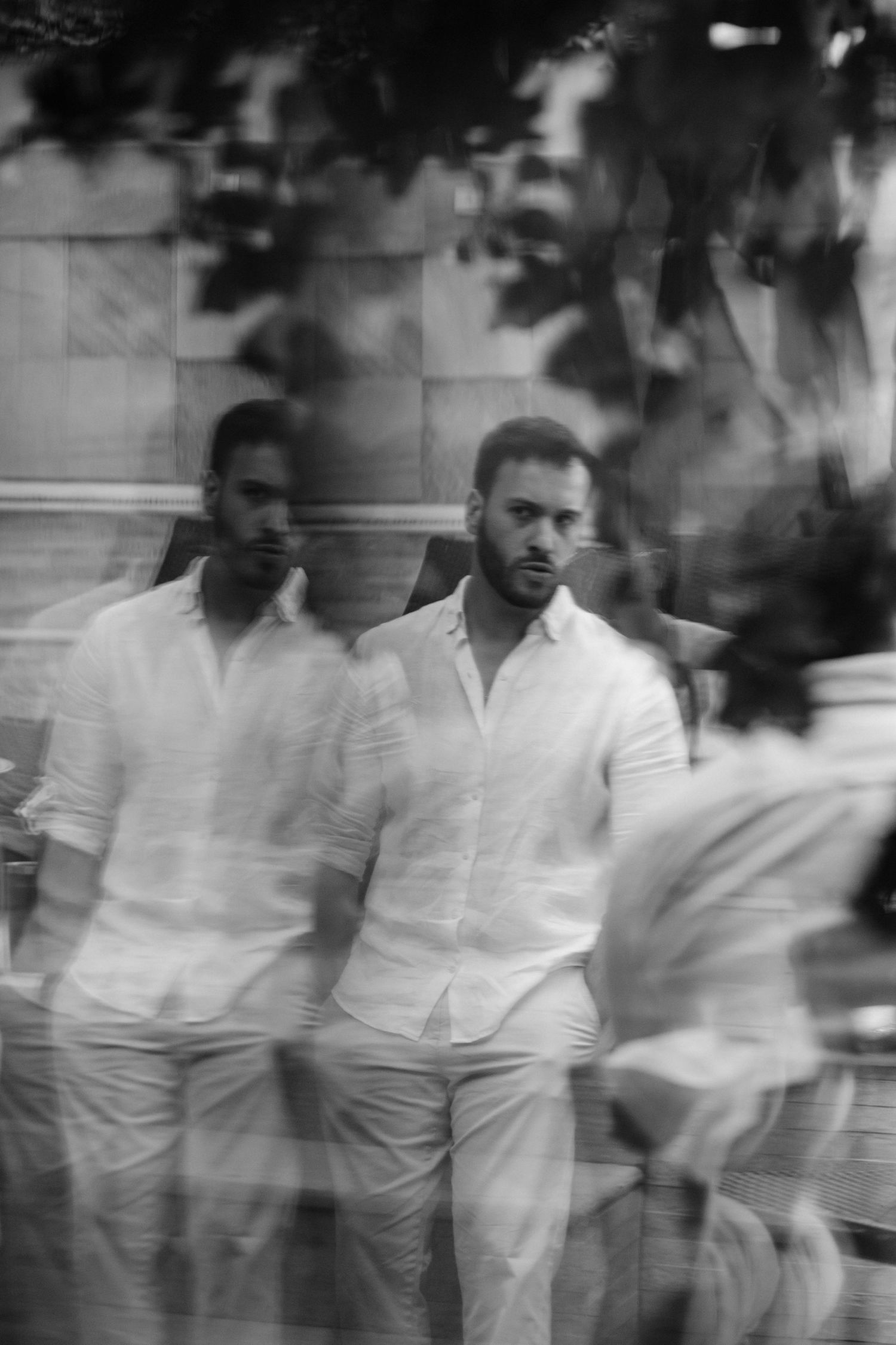 An artistic double exposure portrait of men in white shirts creates a dreamy effect.