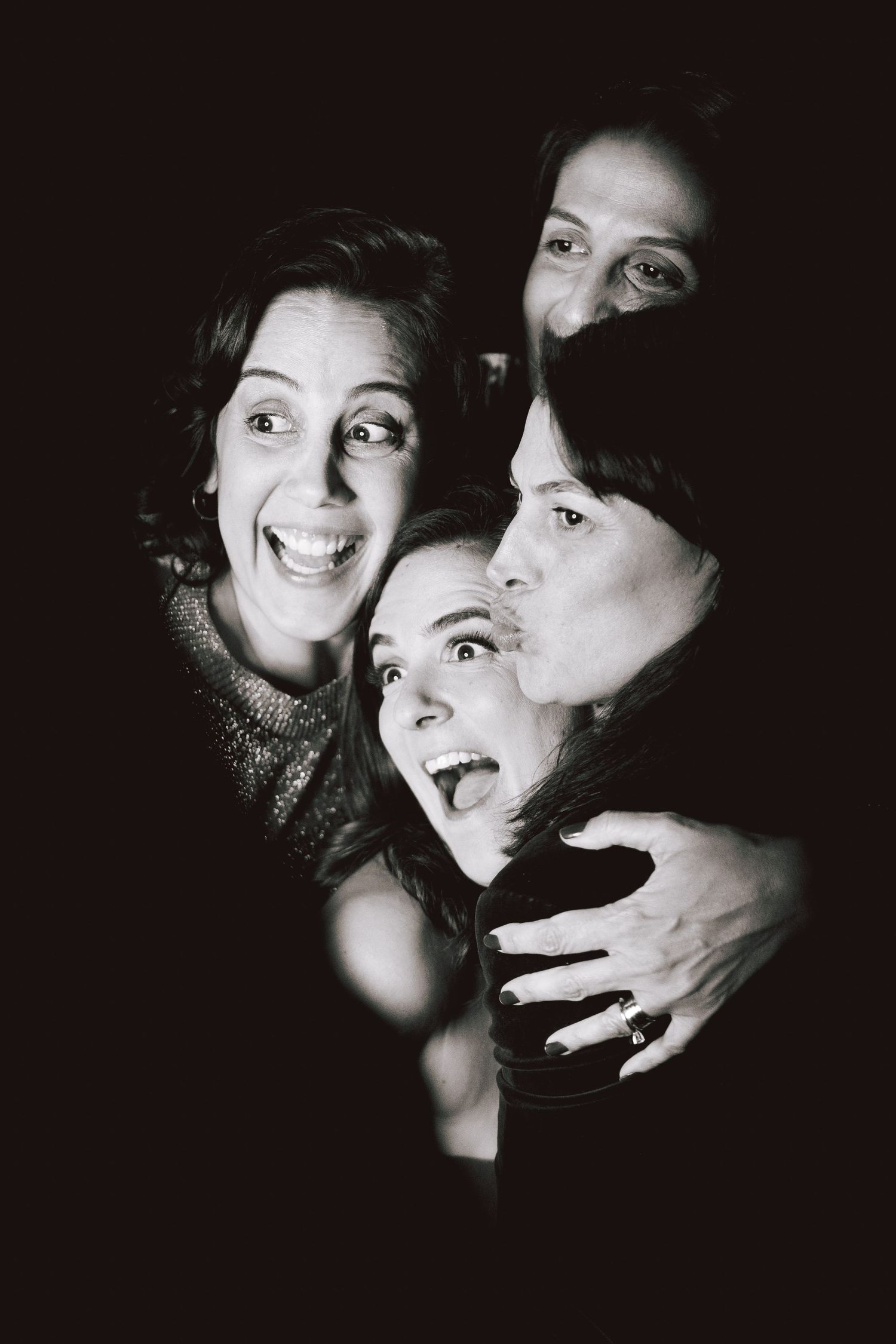 Dramatic black and white portraits showing expressive faces and emotions in dark lighting.