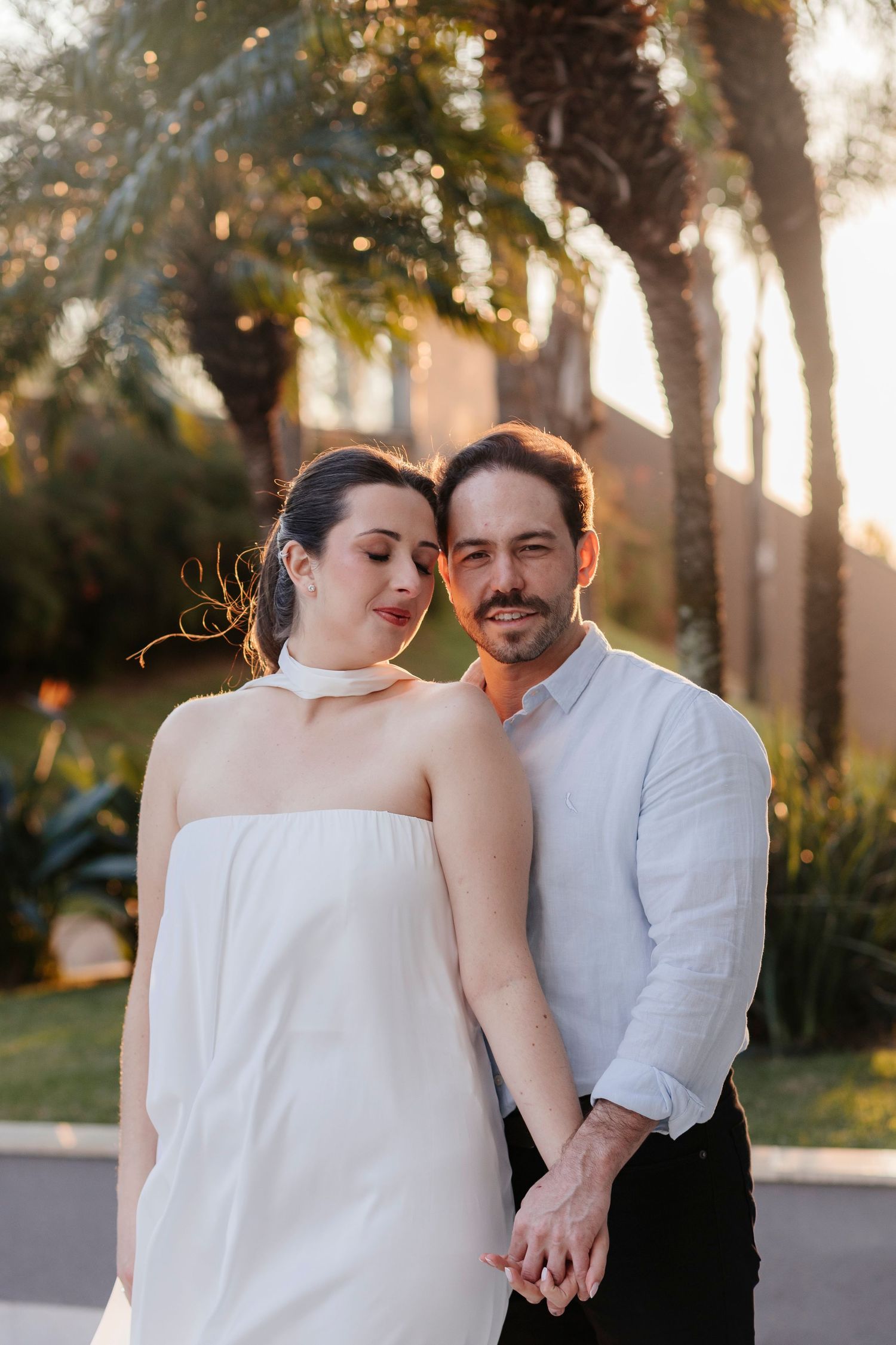 Romantic sunset portrait of couple in white and formal attire.