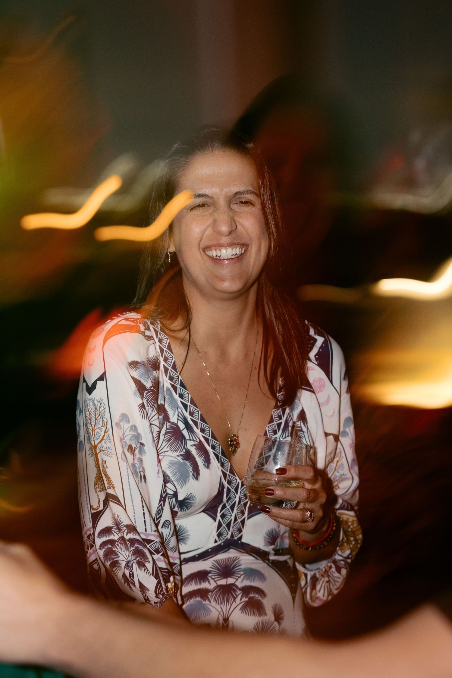 A series of candid shots showing someone in a floral print blouse enjoying a social gathering.
