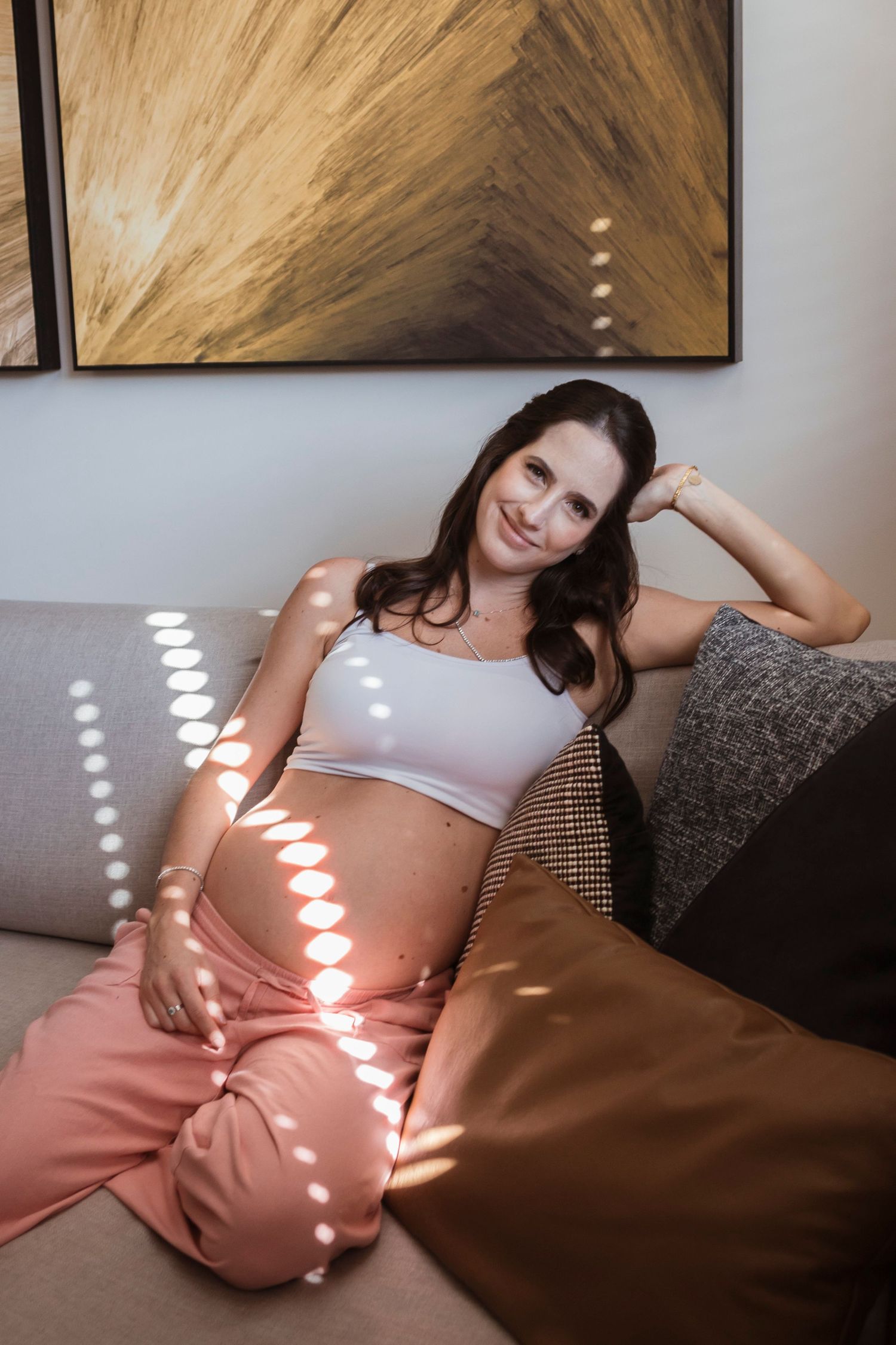 A series of photos showing someone reclining on a brown couch while sunlight creates circular patterns through window blinds.