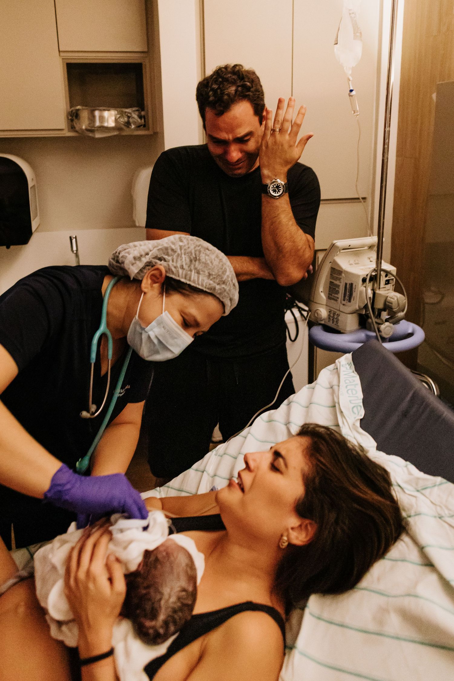 Medical staff assists during childbirth in a hospital delivery room.
