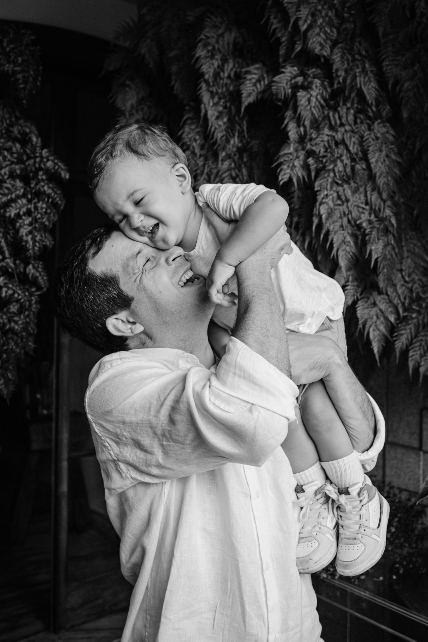 A tender black and white portrait capturing a joyful moment between a parent and child playing together.